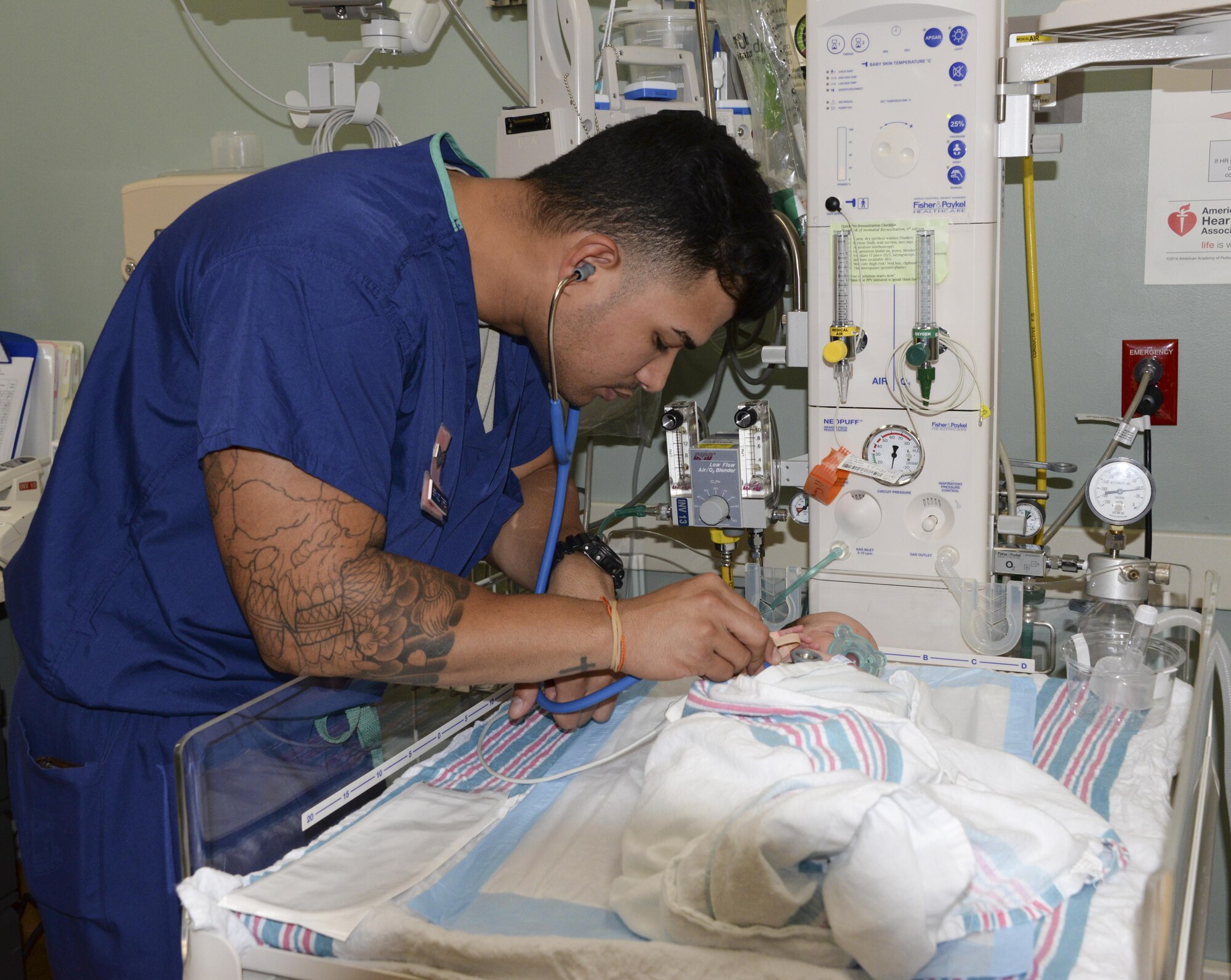 Senior Airman Juan Bermudez Torres, 60th IPTS aerospace medical technician, performs a newborn wellness check Aug. 23 at Travis Air Force Base, Calif. The Maternal Child Flight provides care for child-bearing women and their newborns with more than 400 deliveries annually. 