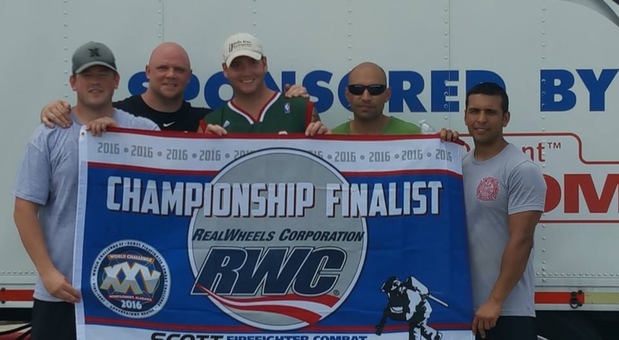 Fire Captain Mark Deboe and Firefighters Milo Gardea, Matthew Rader, Mark Veenstra and Francisco Garibaldi, hold their championship finalist flag after competing in the regional Firefighter Combat Challenge in Sulphur Springs, Texas, Aug. 12-13, 2016. Their five-man team finished the competition with a time of 1:41 in the relay elimination challenge,qualifying them to participate in the worldwide Firefighter Combat Challenge event in Montgomery, Alabama, from Oct. 24-29, 2016. (U.S. Air Force courtesy photo by Mark Deboe)