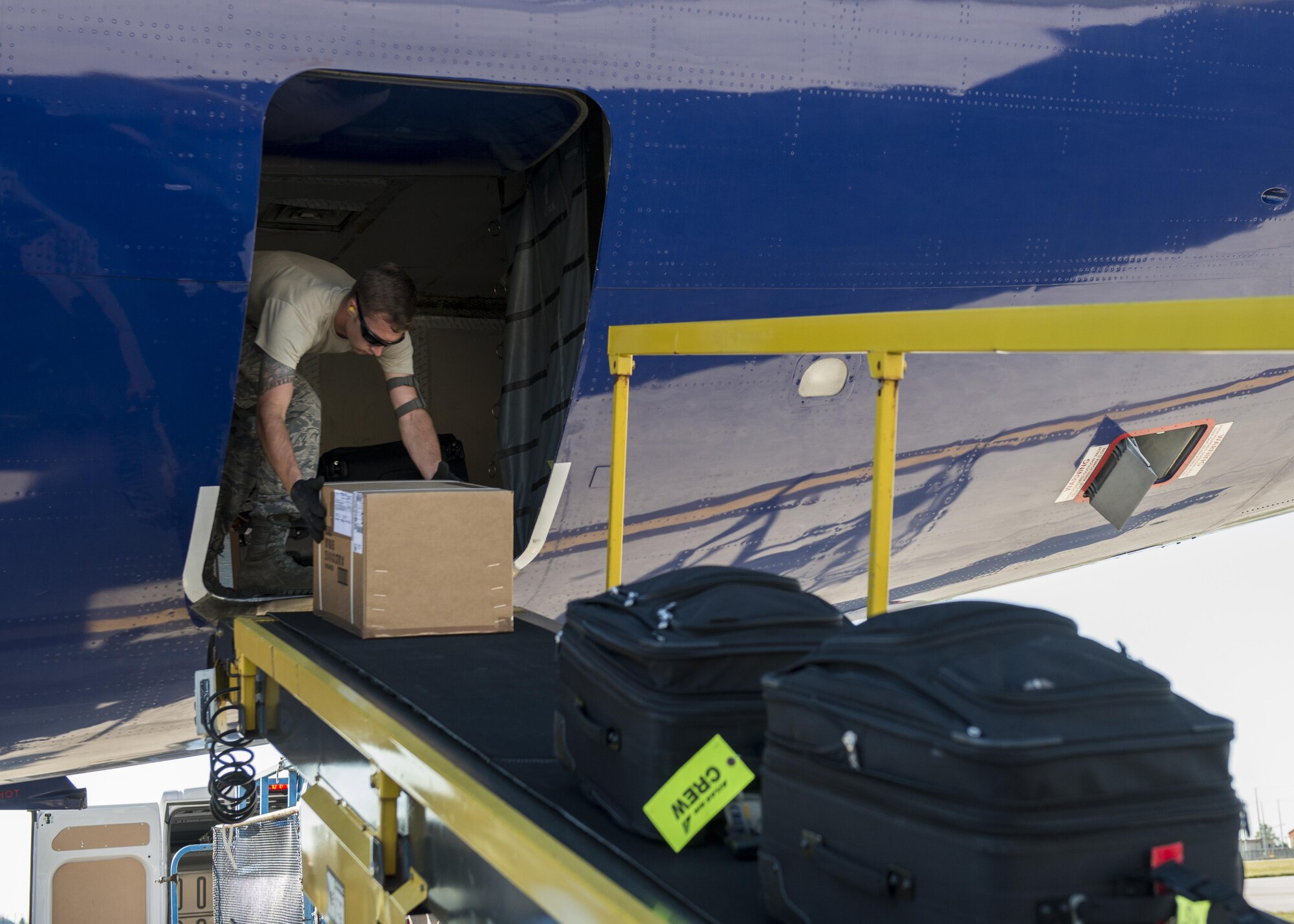 Senior Airman Thomas Harper, 724th Air Mobility Squadron passenger service agent, loads luggage onto an aircraft Aug. 24, 2016, at Aviano Air Base, Italy. The 724th AMS passenger terminal offers a variety of travel options for military members including the Air Mobility Command’s Patriot Express and space-available flights on military aircraft.  (U.S. Air Force photo by Senior Airman Krystal Ardrey/Released)