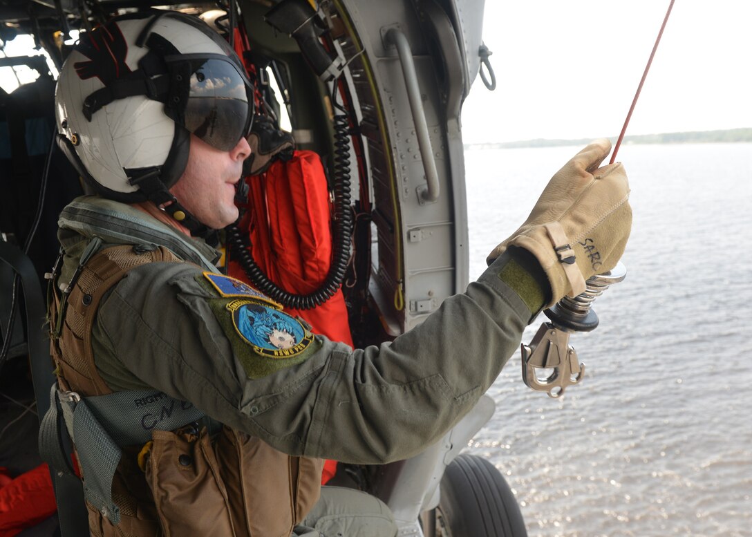 Navy Petty Officer 1st Class Christopher Nelson prepares to conduct search and rescue extraction training from a MH-60S helicopter at Naval Support Activity Panama City, Fla., Aug. 24, 2016. The helicopter and crew are assigned to assigned to Naval Surface Warfare Center Panama City Division's aviation unit. Navy photo by Petty Officer 2nd Class Fred Gray IV
