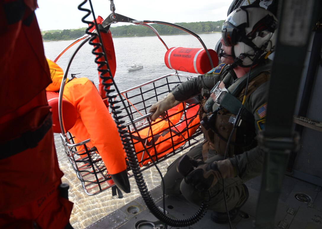 Navy Petty Officer 1st Class Christopher Nelson recovers a dummy in a search and rescue basket during extraction training at Naval Support Activity Panama City, Fla., Aug. 24, 2016. Navy photo by Petty Officer 2nd Class Fred Gray IV