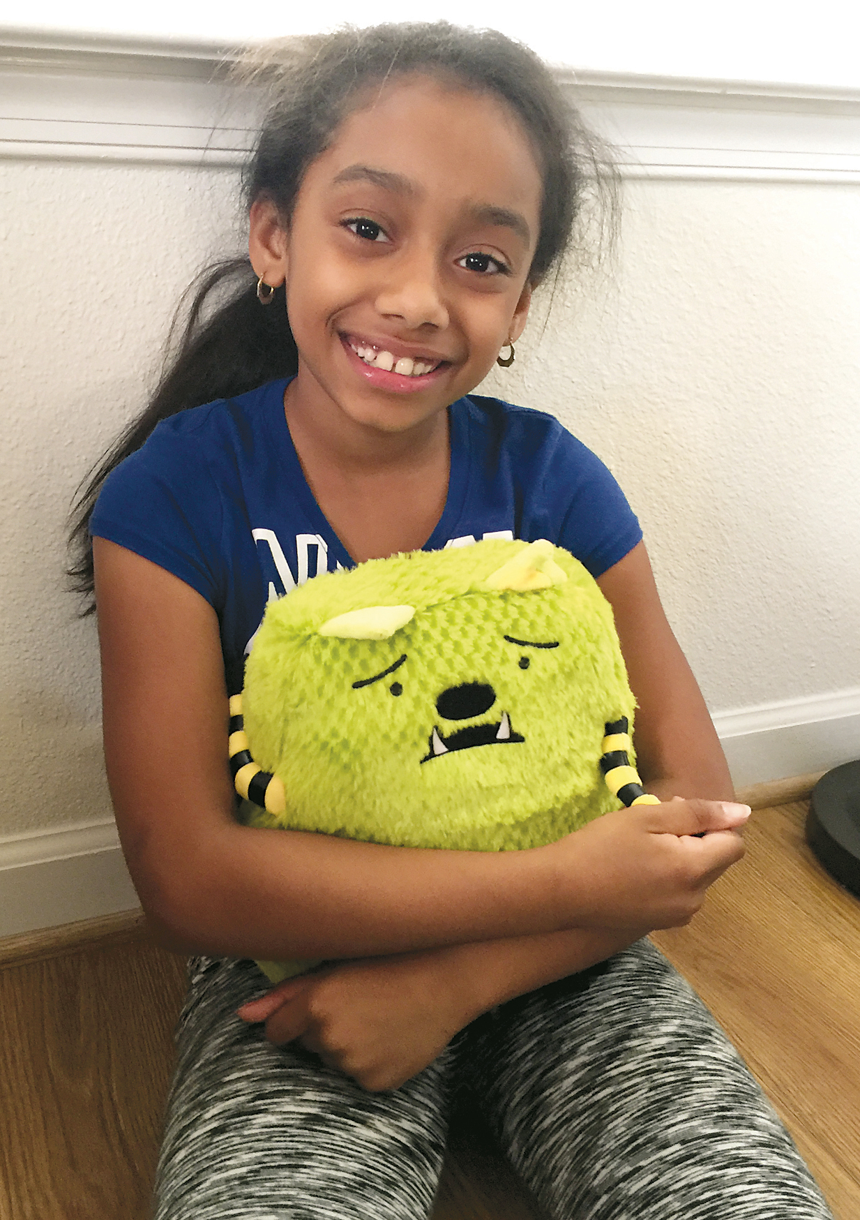 The Polanco's older daughter cuddles her plush Whatif Monster. Milly Polanco held a fundraiser this past April to purchase sets of the plush monster and its accompanying book, "Jonathan James and the Whatif Monster," for children working with the FOCUS team aboard Marine Corps Base Quantico. Photo courtesy Milly Polanco. 