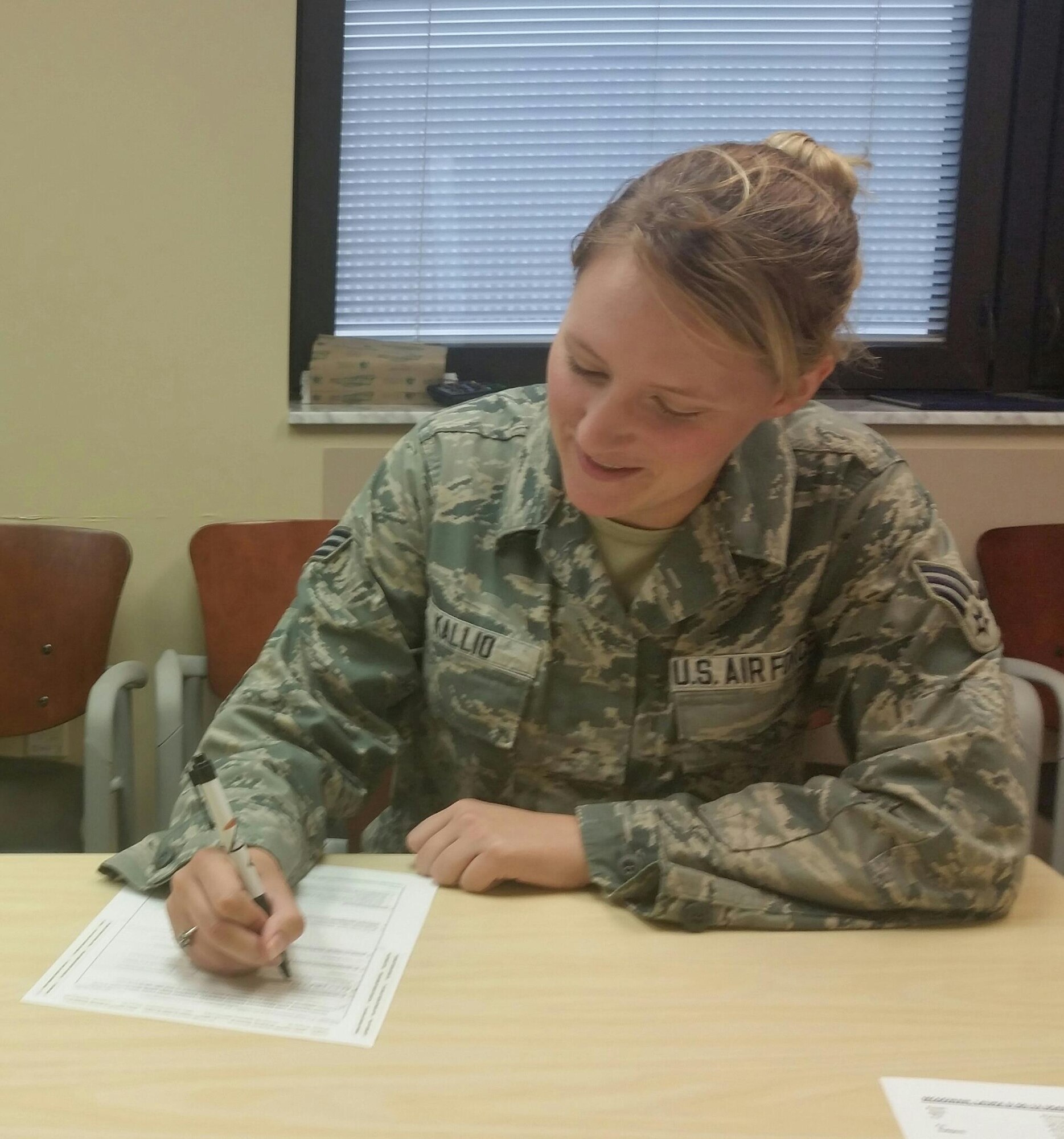 SrA Brittaney Kallio, paralegal with 88th Air Base Wing Judge Advocate, is filling out paperwork for the upcoming Presidential election.  (U.S. Air Force Photo / Laura McGowan)