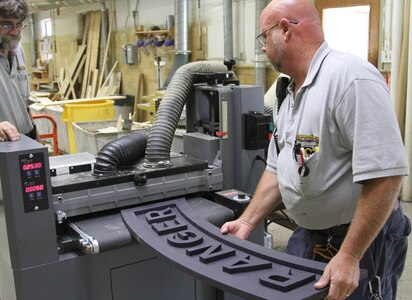 Muscatatuck, Ind.- Bill LaFollette and Shawn Kostek work together to produce special order projects at the Muscatatuck Urban Training Center Carpentry Shop in Butlerville, Ind., Aug. 22, 2016. Both have worked here for the past 20 years. (U.S. Army Photo by Spc. Eddie Serra)