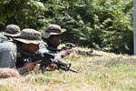 Simulated opposing forces members Airman 1st Class Jared Small, left, and Staff Sgt. Michael Denson, 51st Security Forces Squadron Defenders, move in position to attack during Exercise Beverly Herd 16-2, on Osan Air Base, Aug. 24, 2016.  The exercise provides U.S. armed forces the opportunity to hone fighting skills that can be used in real-world contingencies. 