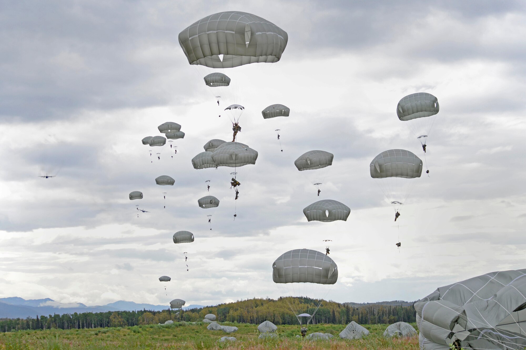 Paratroopers assigned to the 4th Infantry Brigade Combat Team (Airborne), 25th Infantry Division, U.S. Army Alaska, jump from a C-17 Globemaster III during a joint forcible entry exercise at Malemute Drop Zone on Joint Base Elmendorf-Richardson, Alaska, Aug. 23, 2016, as part of Exercise Spartan Agoge. Spartan Agoge is a brigade-level field training exercise that began Aug. 15, and focuses on an array of combat-related tasks from squad live-fire exercises to helicopter air insertion and airborne assault training. (U.S. Air Force photo by Airman 1st Class Valerie Monroy)