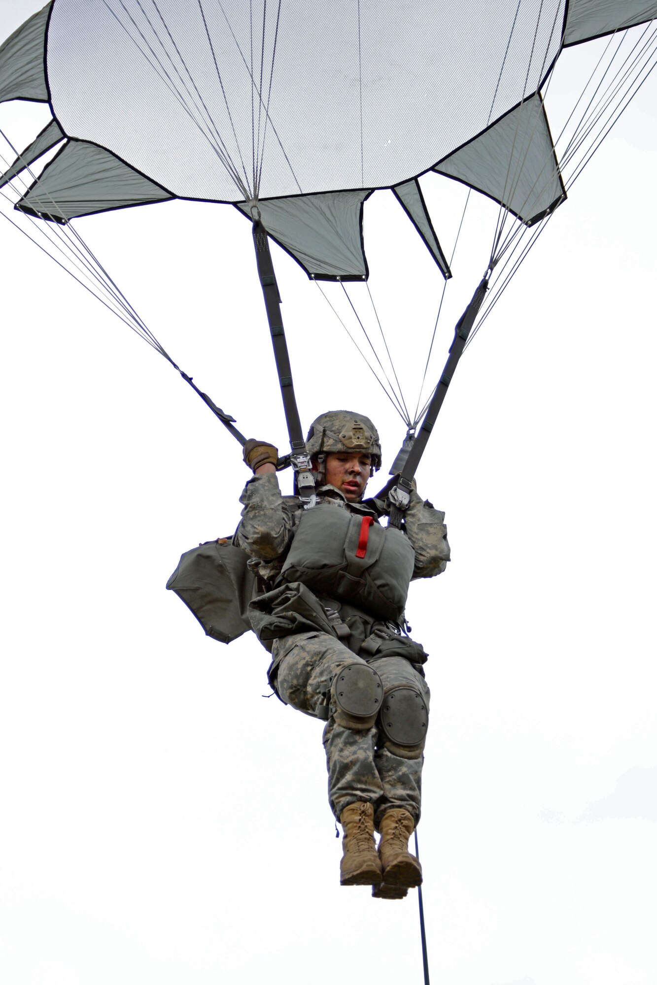 A paratrooper assigned to 1st Battalion, 501st Parachute Infantry Regiment, 4th Infantry Brigade Combat Team (Airborne), 25th Infantry Division, U.S. Army Alaska, prepares to land during a joint forcible entry exercise at Malemute Drop Zone on Joint Base Elmendorf-Richardson, Alaska, Aug. 23, 2016, as part of Exercise Spartan Agoge. Spartan Agoge is a brigade-level field training exercise that began Aug. 15, and focuses on an array of combat-related tasks from squad live-fire exercises to helicopter air insertion and airborne assault training. (U.S. Air Force photo by Airman 1st Class Valerie Monroy)