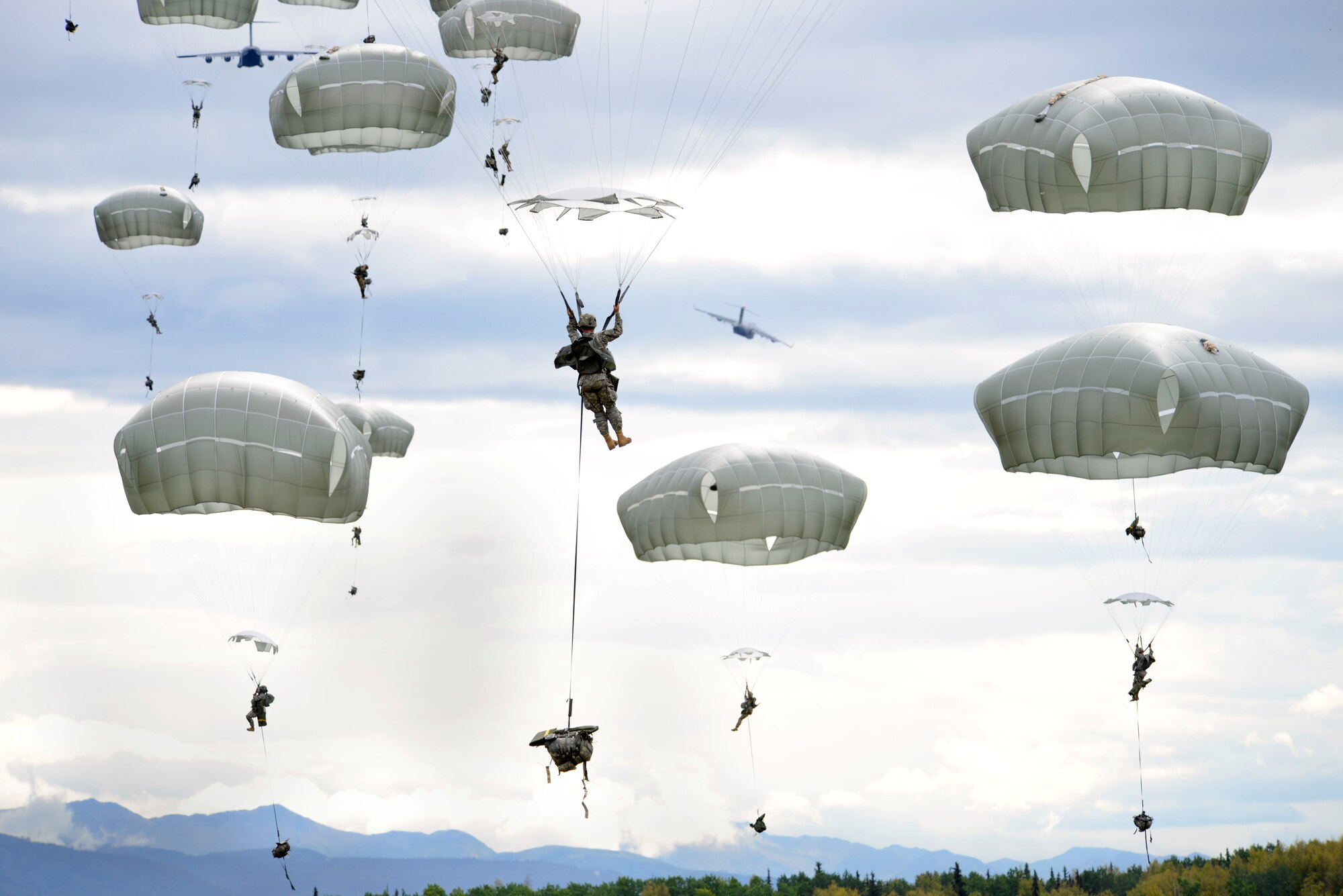Paratroopers assigned to the 4th Infantry Brigade Combat Team (Airborne), 25th Infantry Division, U.S. Army Alaska, jump from a C-17 Globemaster III during a joint forcible entry exercise at Malemute Drop Zone on Joint Base Elmendorf-Richardson, Alaska, Aug. 23, 2016, as part of Exercise Spartan Agoge. Spartan Agoge is a brigade-level field training exercise that began Aug. 15, and focuses on an array of combat-related tasks from squad live-fire exercises to helicopter air insertion and airborne assault training. (U.S. Air Force photo by Airman 1st Class Valerie Monroy)