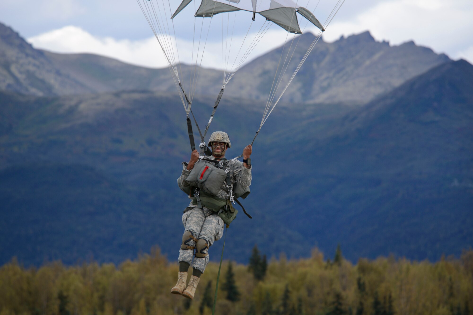 Army Staff Sgt. Kevin Brown, assigned to the 1st Battalion, 501st Parachute Infantry Regiment,4th Infantry Brigade Combat Team (Airborne), 25th Infantry Division, U.S. Army Alaska, prepares to land during a joint forcible entry exercise at Malemute Drop Zone on Joint Base Elmendorf-Richardson, Alaska, Aug. 23, 2016, as part of Exercise Spartan Agoge. Spartan Agoge is a brigade-level field training exercise that began Aug. 15, and focuses on an array of combat-related tasks from squad live-fire exercises to helicopter air insertion and airborne assault training. (U.S. Air Force photo by Airman 1st Class Valerie Monroy)