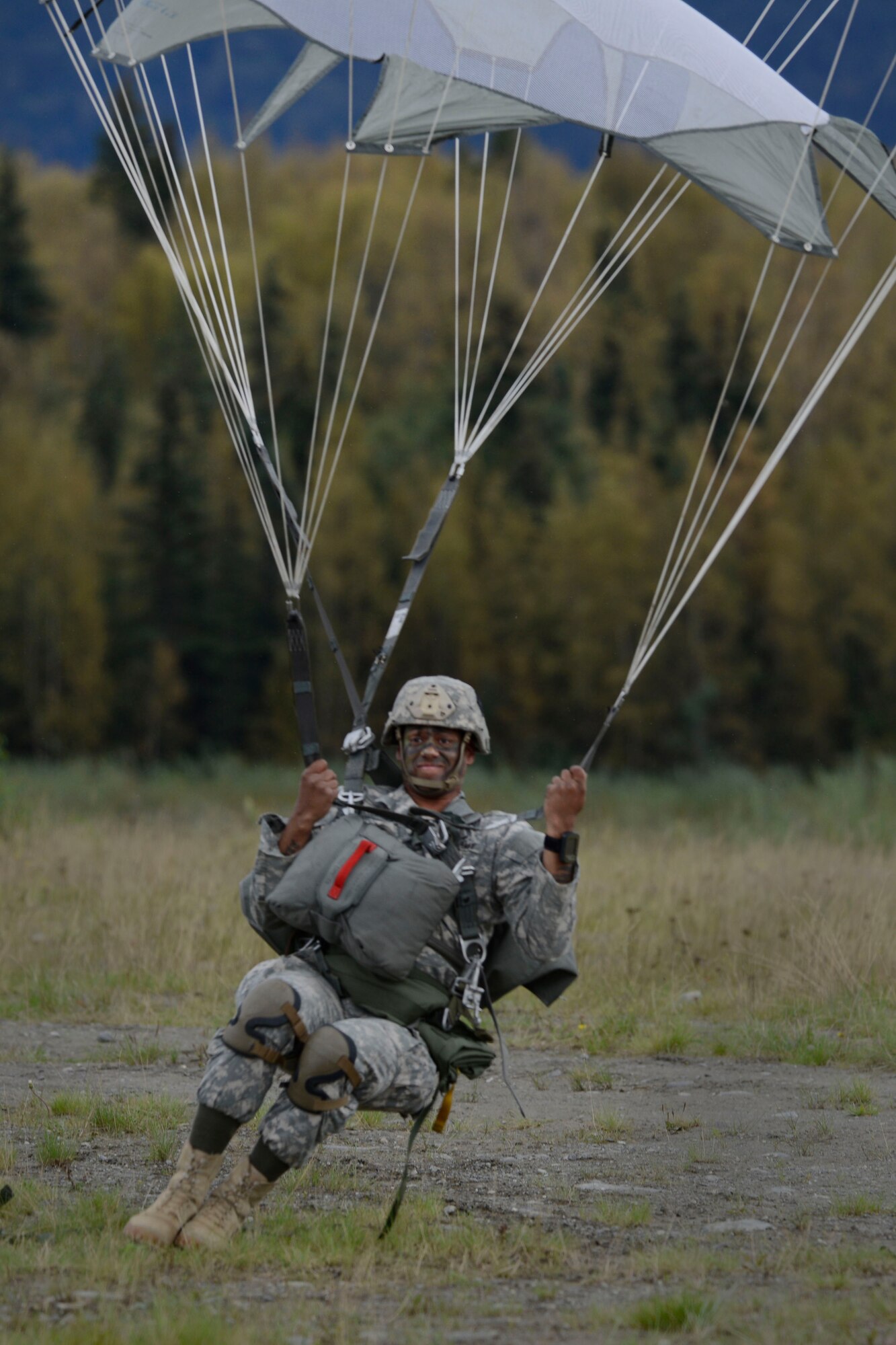 Army Staff Sgt. Kevin Brown, assigned to the 1st Battalion, 501st Parachute Infantry Regiment, 4th Infantry Brigade Combat Team (Airborne), 25th Infantry Division, U.S. Army Alaska, prepares to land during a joint forcible entry exercise at Malemute Drop Zone on Joint Base Elmendorf-Richardson, Alaska, Aug. 23, 2016, as part of Exercise Spartan Agoge. Spartan Agoge is a brigade-level field training exercise that began Aug. 15, and focuses on an array of combat-related tasks from squad live-fire exercises to helicopter air insertion and airborne assault training. (U.S. Air Force photo by Airman 1st Class Valerie Monroy)