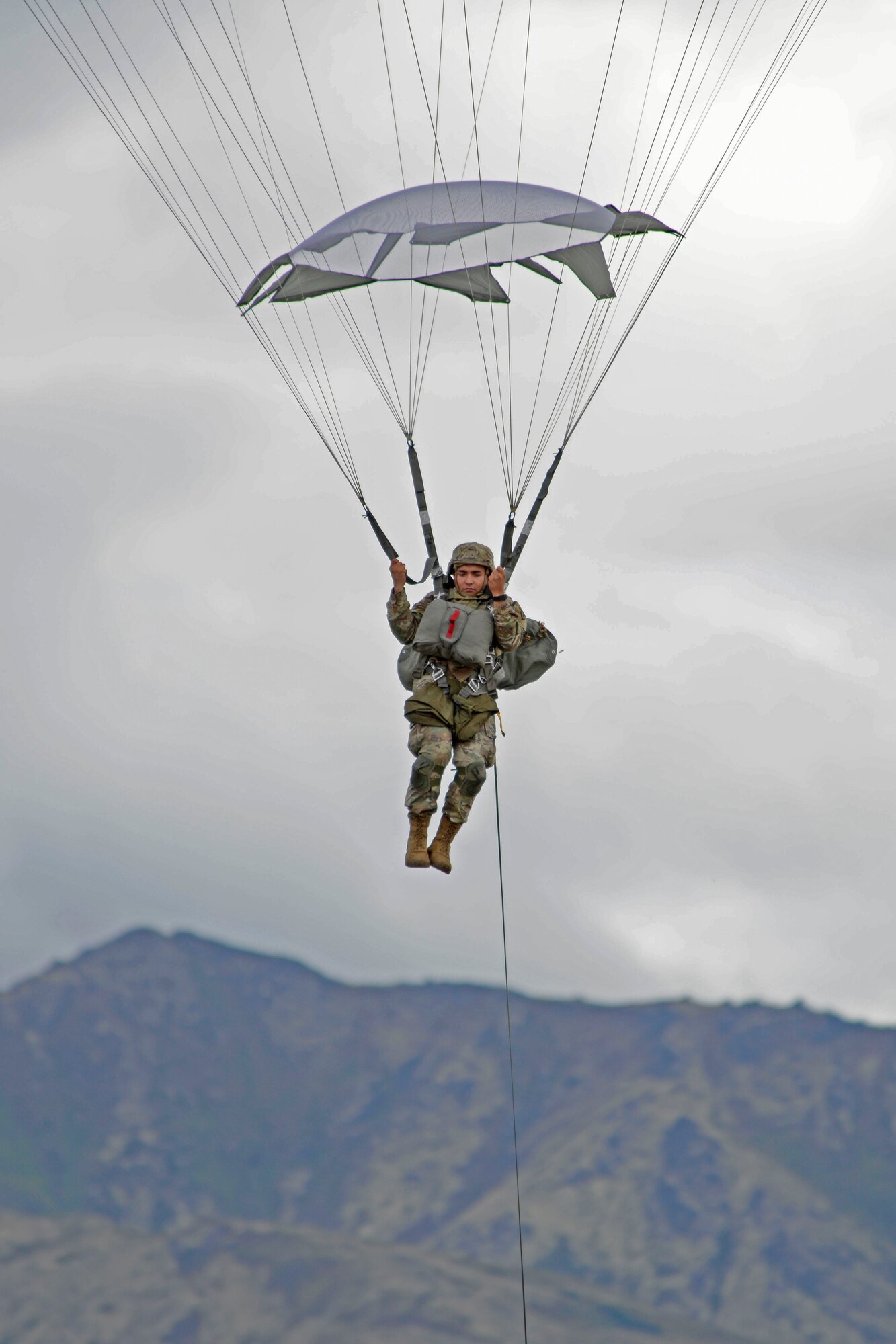 A paratrooper assigned to the 4th Infantry Brigade Combat Team (Airborne), 25th Infantry Division, U.S. Army Alaska, prepares to land during a joint forcible entry exercise at Malemute Drop Zone on Joint Base Elmendorf-Richardson, Alaska, Aug. 23, 2016, as part of Exercise Spartan Agoge. Spartan Agoge is a brigade-level field training exercise that began Aug. 15, and focuses on an array of combat-related tasks from squad live-fire exercises to helicopter air insertion and airborne assault training. (U.S. Air Force photo by Airman 1st Class Valerie Monroy)