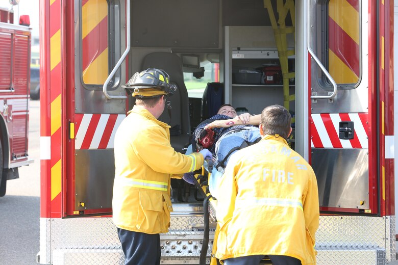 Firefighters with the Marine Corps Air Station Miramar Fire Department load a simulated casualty into an ambulance during an aircraft mass casualty exercise aboard MCAS Miramar, Calif., Aug. 24. Marines with Aircraft Rescue and Firefighting and firefighters with the MCAS Miramar Fire Department worked alongside San Diego first responders to improve response times, solidify existing standard operating procedures for emergencies and fulfill annual training requirements. (U.S. Marine Corps photo by Pfc. Jake M.T. McClung/Released)