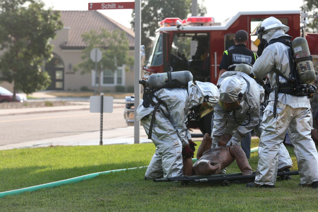 Marines with Aircraft Rescue and Firefighting remove a simulated casualty from a stretcher during an aircraft mass casualty exercise aboard Marine Corps Air Station Miramar, Calif., Aug. 24. Marines with ARFF and firefighters with MCAS Miramar’s Fire Department worked alongside San Diego first responders to improve response times, solidify existing standard operating procedures for emergencies and fulfill annual training requirements. (U.S. Marine Corps photo by Pfc. Jake M.T. McClung/Released)