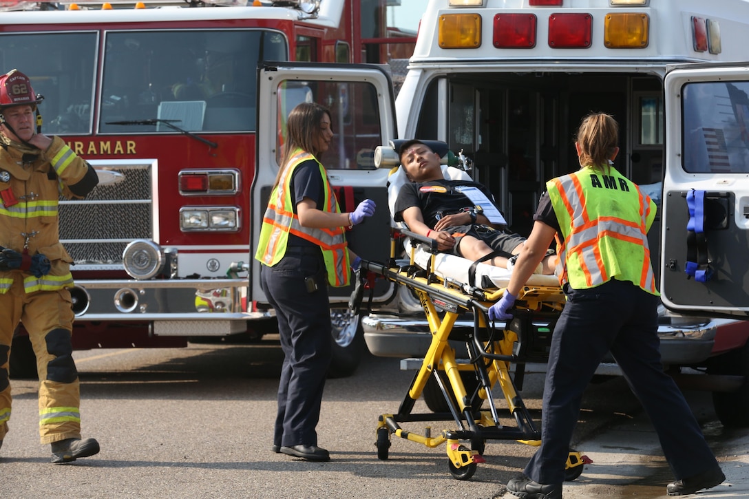 San Diego Emergency Medical Services paramedics load a simulated casualty into an ambulance during an aircraft mass casualty exercise aboard Marine Corps Air Station Miramar, Calif., Aug. 24. Marines with Aircraft Rescue and Firefighting and firefighters with the MCAS Miramar Fire Department worked alongside San Diego first responders to improve response times, solidify existing standard operating procedures for emergencies and fulfill annual training requirements. (U.S. Marine Corps photo by Pfc. Jake M.T. McClung/Released)