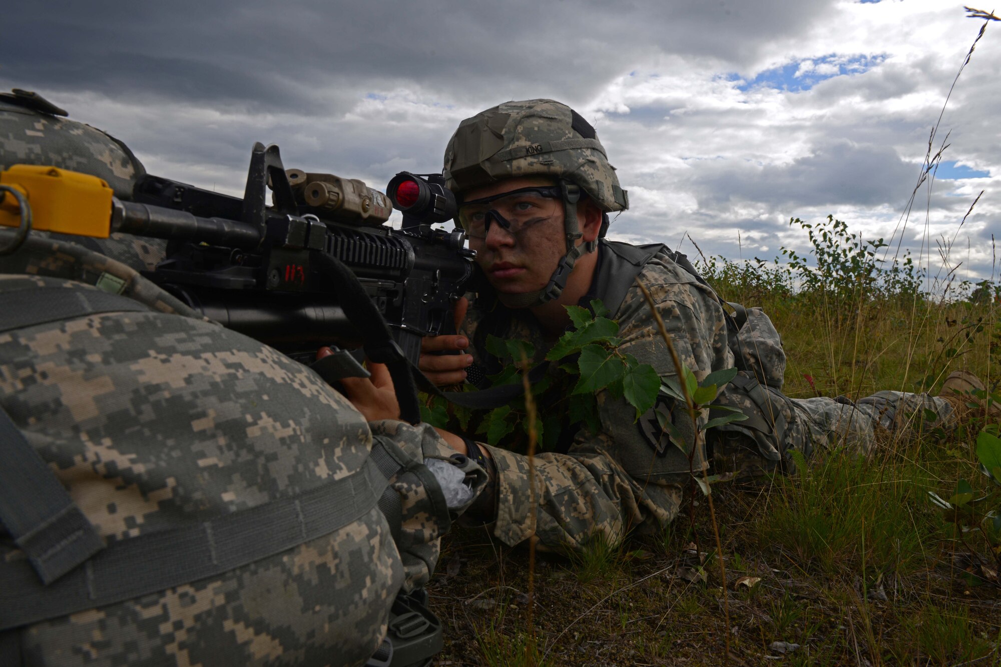Pfc. Aidan King, a paratrooper assigned to 1st Battalion, 501st Parachute Infantry Regiment, 4th Infantry Brigade Combat Team (Airborne), 25th Infantry Division, U.S. Army Alaska, looks down the scope of his weapon during a joint forcible entry exercise at Malemute Drop Zone on Joint Base Elmendorf-Richardson, Alaska, Aug. 23, 2016, as part of Exercise Spartan Agoge. Spartan Agoge is a brigade-level field training exercise that began Aug. 15, focused on an array of combat-related tasks from squad live-fire exercises to helicopter air insertion and airborne training. (U.S. Air Force Airman 1st Class Javier Alvarez)