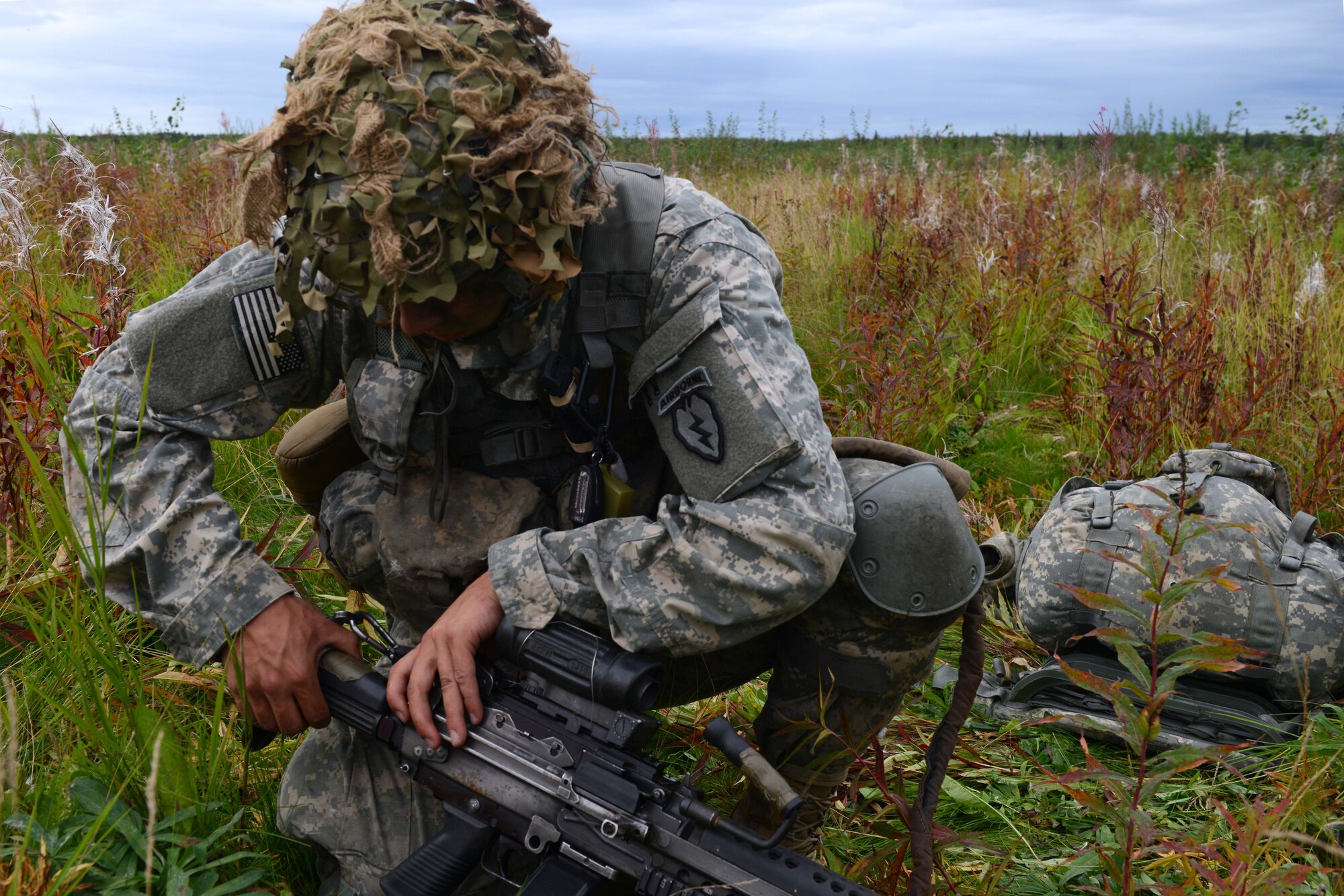 A paratrooper assigned to the 4th Infantry Brigade Combat Team (Airborne), 25th Infantry Division, U.S. Army Alaska, places his weapon into operation during a joint forcible entry exercise at Malemute Drop Zone on Joint Base Elmendorf-Richardson, Alaska, Aug. 23, 2016, as part of Exercise Spartan Agoge. Spartan Agoge is a brigade-level field training exercise that began Aug. 15, focused on an array of combat-related tasks from squad live-fire exercises to helicopter air insertion and airborne training. (U.S. Air Force Airman 1st Class Javier Alvarez)