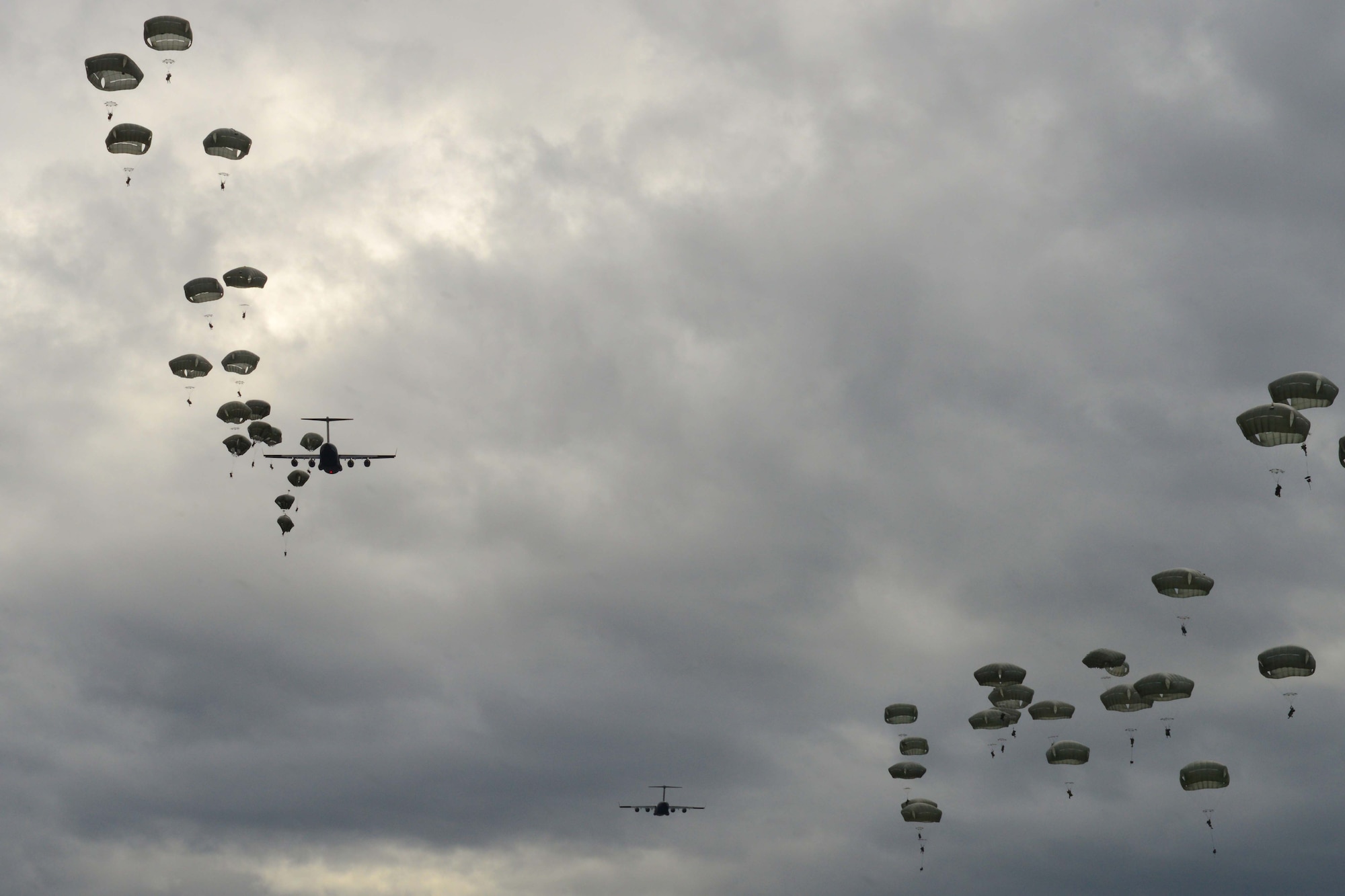 Paratroopers assigned to the 4th Infantry Brigade Combat Team (Airborne), 25th Infantry Division, U.S. Army Alaska, glide toward their target during a joint forcible entry exercise at Malemute Drop Zone on Joint Base Elmendorf-Richardson, Alaska, Aug. 23, 2016, as part of Exercise Spartan Agoge. Spartan Agoge is a brigade-level field training exercise that began Aug. 15, focused on an array of combat-related tasks from squad live-fire exercises to helicopter air insertion and airborne training. (U.S. Air Force Airman 1st Class Javier Alvarez)