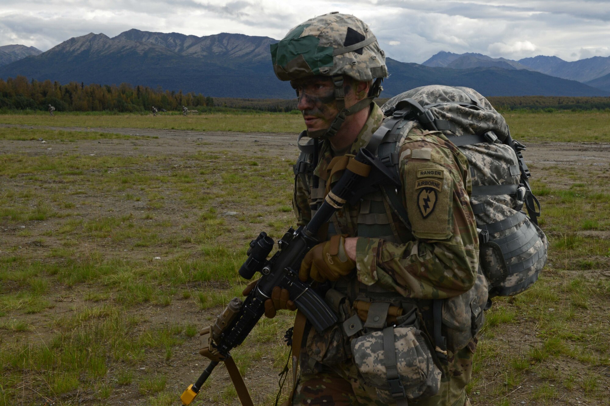 A paratrooper assigned to 1st Battalion, 501st Parachute Infantry Regiment, 4th Infantry Brigade Combat Team (Airborne), 25th Infantry Division, U.S. Army Alaska, heads for his assembly area during a joint forcible entry exercise at Malemute Drop Zone on Joint Base Elmendorf-Richardson, Alaska, Aug. 23, 2016, as part of Exercise Spartan Agoge. Spartan Agoge is a brigade-level field training exercise that began Aug. 15, focused on an array of combat-related tasks from squad live-fire exercises to helicopter air insertion and airborne training. (U.S. Air Force Airman 1st Class Javier Alvarez)