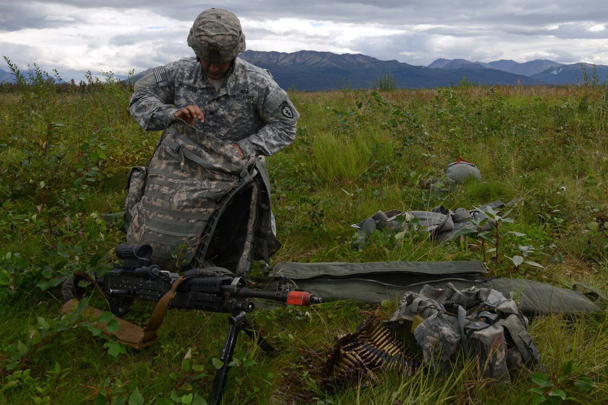 Spc. Christopher Machello, a paratrooper assigned to 1st Battalion, 501st Parachute Infantry Regiment, 4th Infantry Brigade Combat Team (Airborne), 25th Infantry Division, U.S. Army Alaska, inspects his gear during a joint forcible entry exercise at Malemute Drop Zone on Joint Base Elmendorf-Richardson, Alaska, Aug. 23, 2016, as part of Exercise Spartan Agoge. Spartan Agoge is a brigade-level field training exercise that began Aug. 15, focused on an array of combat-related tasks from squad live-fire exercises to helicopter air insertion and airborne training. (U.S. Air Force Airman 1st Class Javier Alvarez)