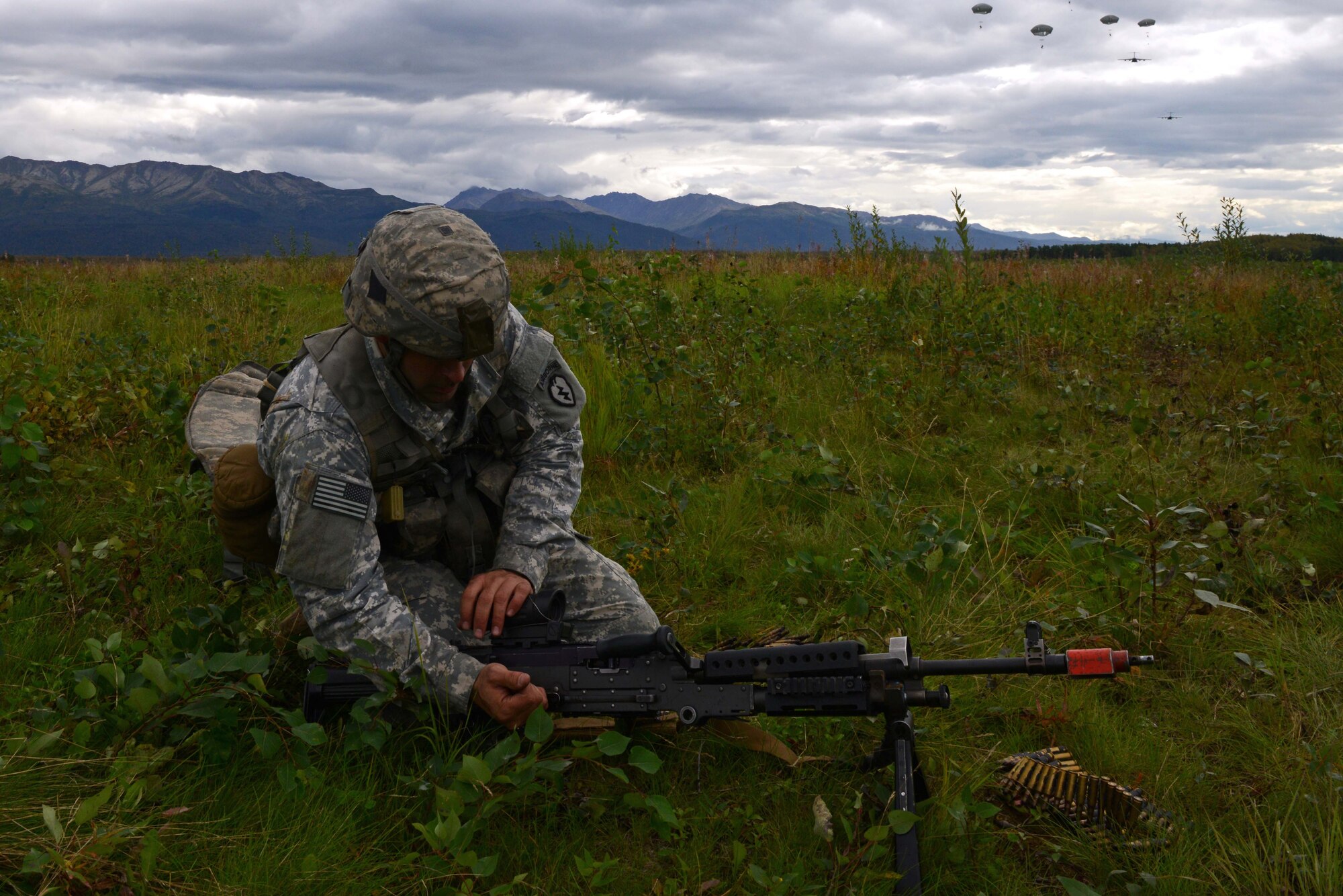 Spc. Christopher Machello, a paratrooper assigned to 1st Battalion, 501st Parachute Infantry Regiment, 4th Infantry Brigade Combat Team (Airborne), 25th Infantry Division, U.S. Army Alaska, places his weapon into operation during a joint forcible entry exercise at Malemute Drop Zone on Joint Base Elmendorf-Richardson, Alaska, Aug. 23, 2016, as part of Exercise Spartan Agoge. Spartan Agoge is a brigade-level field training exercise that began Aug. 15, focused on an array of combat-related tasks from squad live-fire exercises to helicopter air insertion and airborne training. (U.S. Air Force Airman 1st Class Javier Alvarez)
