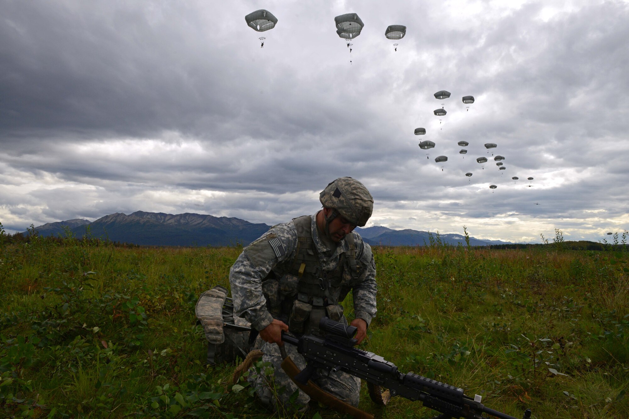 Spc. Christopher Machello, a paratrooper assigned to 1st Battalion, 501st Parachute Infantry Regiment, 4th Infantry Brigade Combat Team (Airborne), 25th Infantry Division, U.S. Army Alaska, places his weapon into operation during a joint forcible entry exercise at Malemute Drop Zone on Joint Base Elmendorf-Richardson, Alaska, Aug. 23, 2016, as part of Exercise Spartan Agoge. Spartan Agoge is a brigade-level field training exercise that began Aug. 15, focused on an array of combat-related tasks from squad live-fire exercises to helicopter air insertion and airborne training. (U.S. Air Force Airman 1st Class Javier Alvarez)