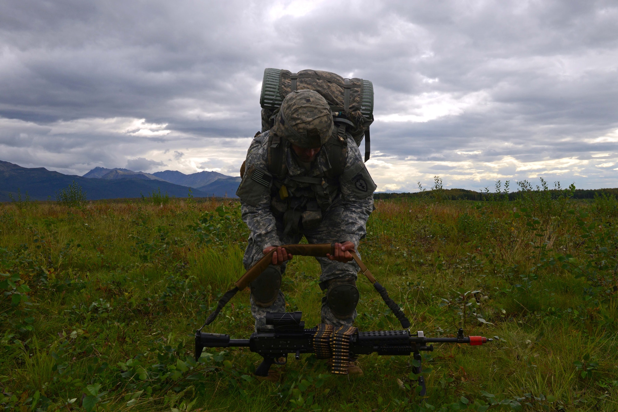 Spc. Christopher Machello, a paratrooper assigned to 1st Battalion, 501st Parachute Infantry Regiment, 4th Infantry Brigade Combat Team (Airborne), 25th Infantry Division, U.S. Army Alaska, lifts his weapon during a joint forcible entry exercise at Malemute Drop Zone on Joint Base Elmendorf-Richardson, Alaska, Aug. 23, 2016, as part of Exercise Spartan Agoge. Spartan Agoge is a brigade-level field training exercise that began Aug. 15, focused on an array of combat-related tasks from squad live-fire exercises to helicopter air insertion and airborne training. (U.S. Air Force Airman 1st Class Javier Alvarez)