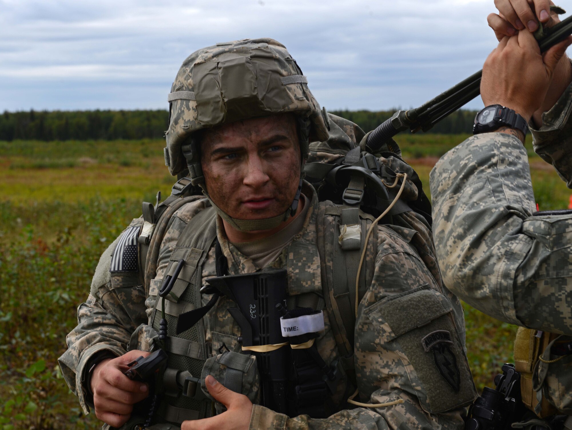 A paratrooper assigned to 1st Battalion, 501st Parachute Infantry Regiment, 4th Infantry Brigade Combat Team (Airborne), 25th Infantry Division, U.S. Army Alaska, watches while his radio antenna is readied following a joint forcible entry exercise at Malemute Drop Zone on Joint Base Elmendorf-Richardson, Alaska, Aug. 23, 2016, as part of Exercise Spartan Agoge. Spartan Agoge is a brigade-level field training exercise that began Aug. 15, focused on an array of combat-related tasks from squad live-fire exercises to helicopter air insertion and airborne training. (U.S. Air Force Airman 1st Class Javier Alvarez)