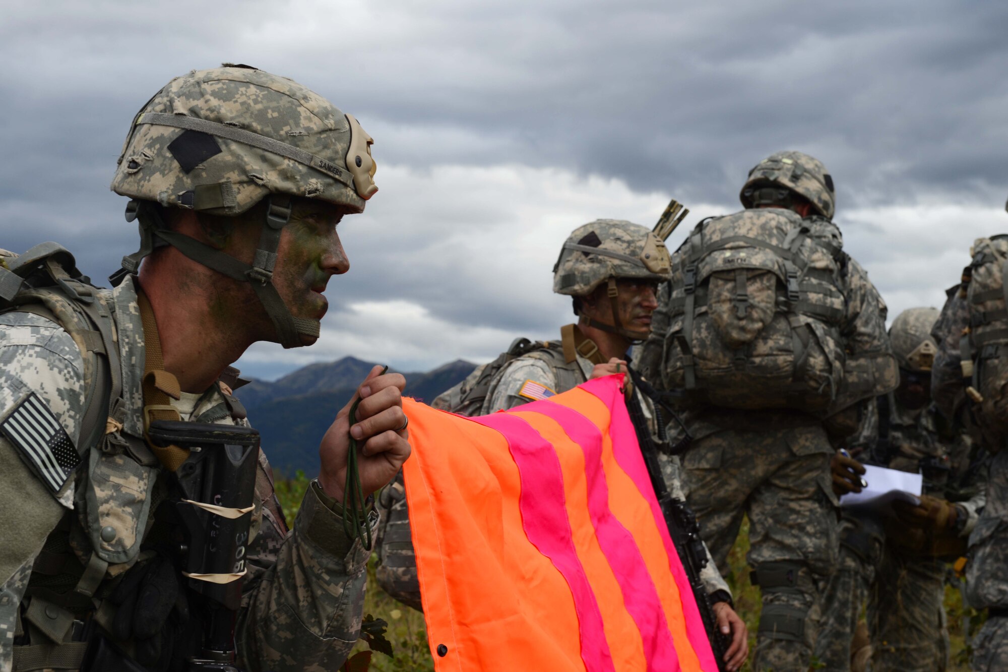 Paratroopers assigned to 1st Battalion, 501st Parachute Infantry Regiment, 4th Infantry Brigade Combat Team (Airborne), 25th Infantry Division, U.S. Army Alaska, mark their assembly area with a VS-17 panel during a joint forcible entry exercise at Malemute Drop Zone on Joint Base Elmendorf-Richardson, Alaska, Aug. 23, 2016, as part of Exercise Spartan Agoge. Spartan Agoge is a brigade-level field training exercise that began Aug. 15, focused on an array of combat-related tasks from squad live-fire exercises to helicopter air insertion and airborne training. (U.S. Air Force Airman 1st Class Javier Alvarez)