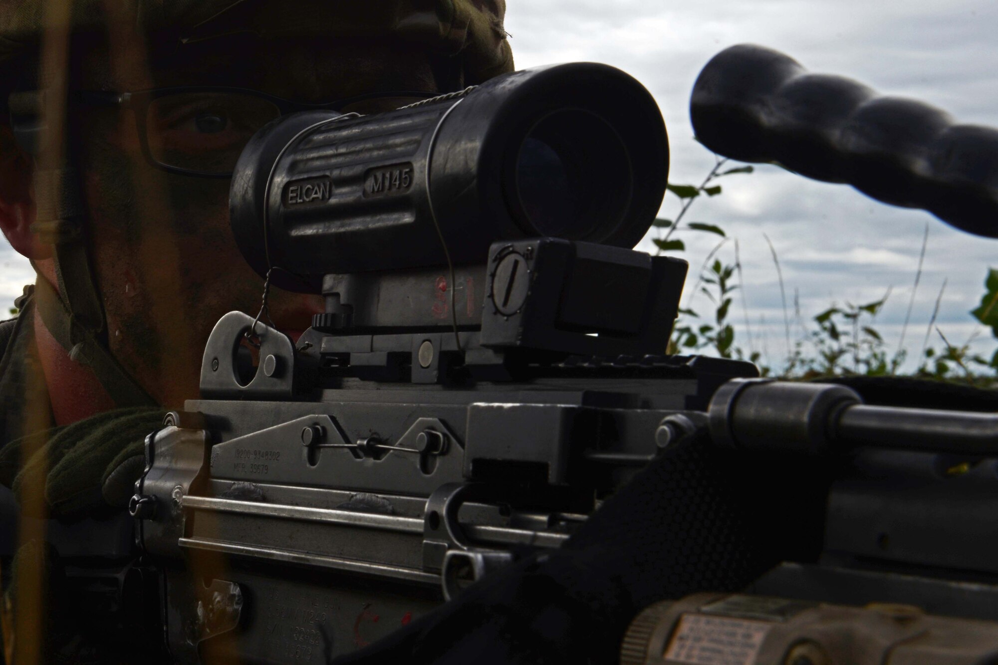 A paratrooper assigned to 1st Battalion, 501st Parachute Infantry Regiment, 4th Infantry Brigade Combat Team (Airborne), 25th Infantry Division, U.S. Army Alaska, looks down the scope of his weapon during a joint forcible entry exercise at Malemute Drop Zone on Joint Base Elmendorf-Richardson, Alaska, Aug. 23, 2016, as part of Exercise Spartan Agoge. Spartan Agoge is a brigade-level field training exercise that began Aug. 15, focused on an array of combat-related tasks from squad live-fire exercises to helicopter air insertion and airborne training. (U.S. Air Force Airman 1st Class Javier Alvarez)