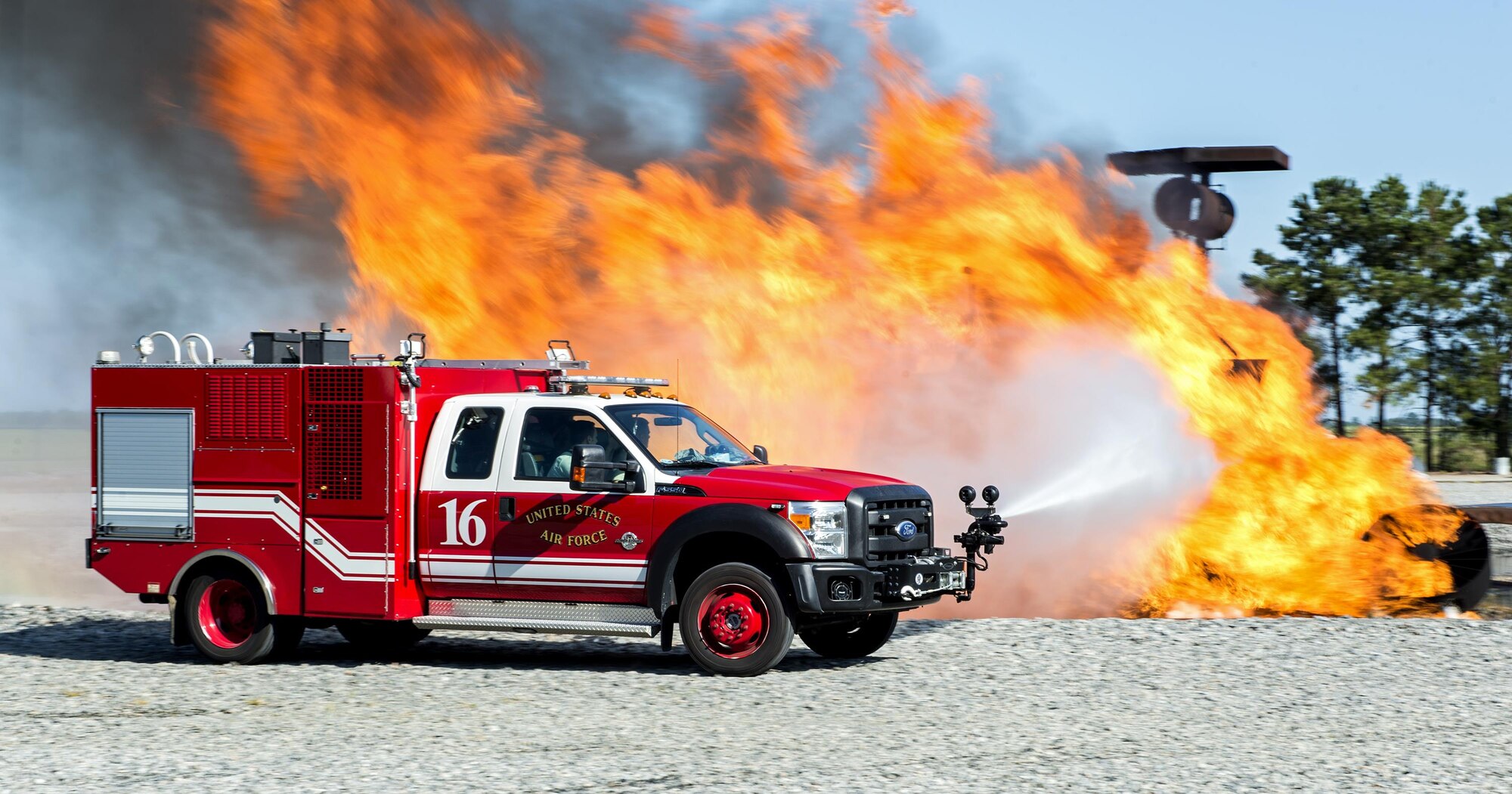 U.S. Air Force firefighters from the 23d Civil Engineer Squadron use high pressure nozzles during a joint live fire training exercise,, Aug. 24, 2016, at Moody Air Force Base, Ga. During a real-world aircraft incident, firefighters would use a foam agent to combat jet fuel flames instead of water. Foam prevents the jet fuel from coming in contact with oxygen and suppresses the combustion that allows it to ignite.  (U.S. Air Force photo by Airman 1st Class Janiqua P. Robinson)