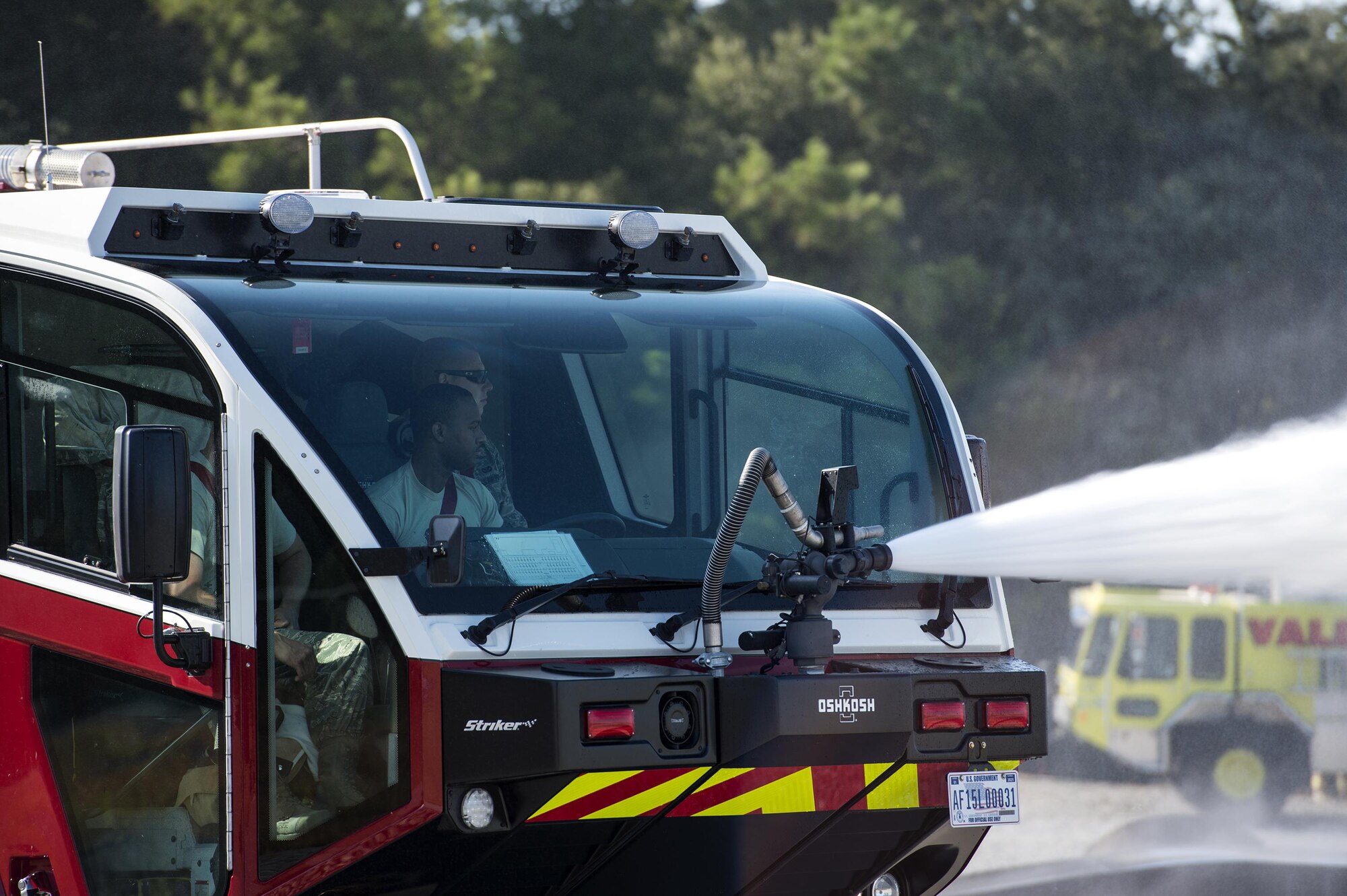 U.S. Air Force firefighters from the 23d Civil Engineer Squadron use high pressure nozzles during a joint live fire training exercise, Aug. 24, 2016, at Moody Air Force Base, Ga. Firefighters from Valdosta Regional Airport and the 23d CES broke into groups and took turns controlling the turret and combating the fire as they would in the field.  This  was the first time the new P-23 fire truck, which houses 3,000 gallons of water, has been used for this training. (U.S. Air Force photo by Airman 1st Class Janiqua P. Robinson)