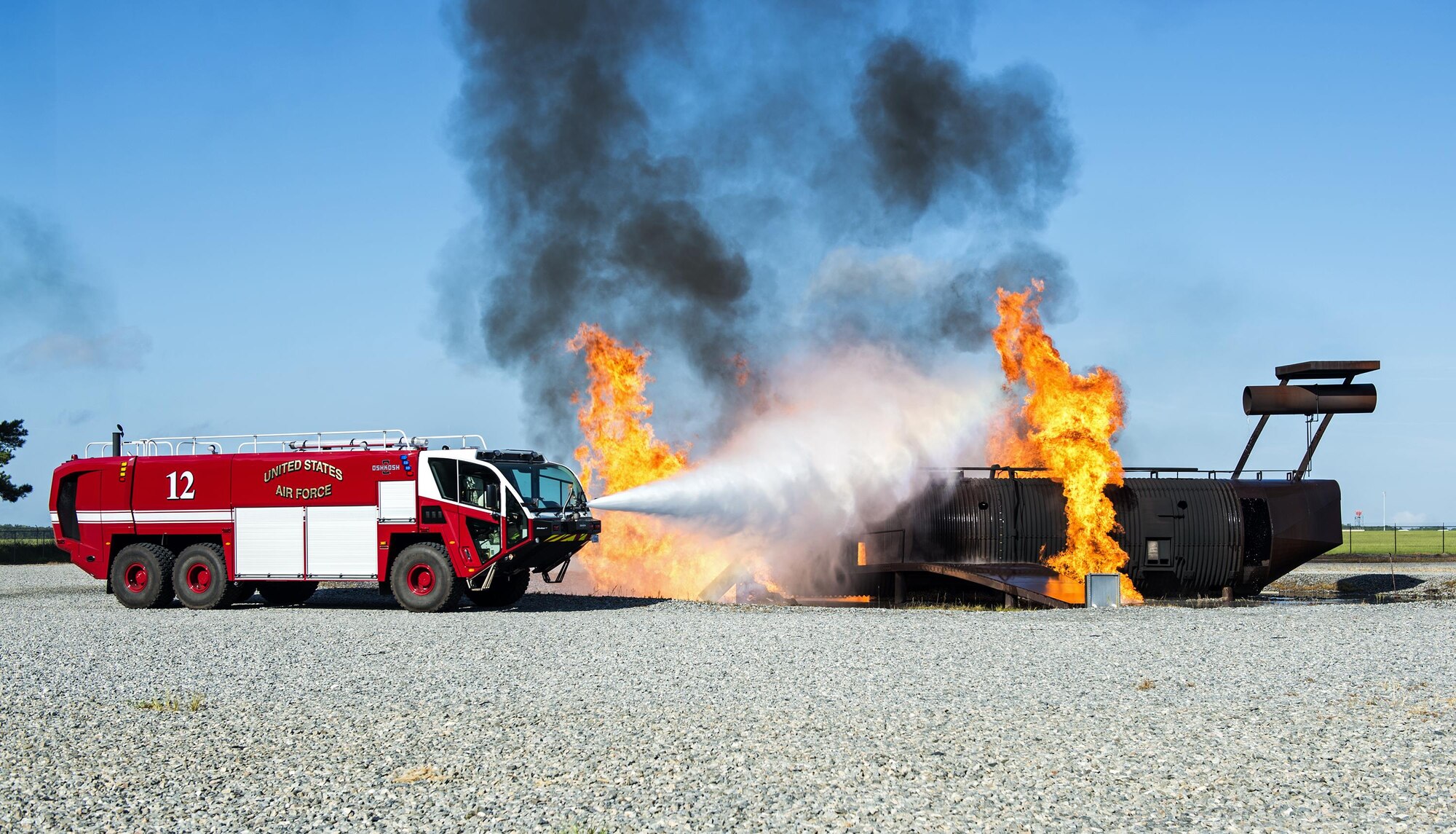 U.S. Air Force firefighters from the 23d Civil Engineer Squadron use a P-23 fire truck to perform exterior firefighting techniques during a joint live fire training exercise, Aug. 24, 2016, at Moody Air Force Base, Ga. Firefighters from Valdosta Regional Airport and the 23d CES teamed up to practice the proper techniques to extinguish a jet fuel fire in case of an aircraft incident. (U.S. Air Force photo by Airman 1st Class Janiqua P. Robinson)
