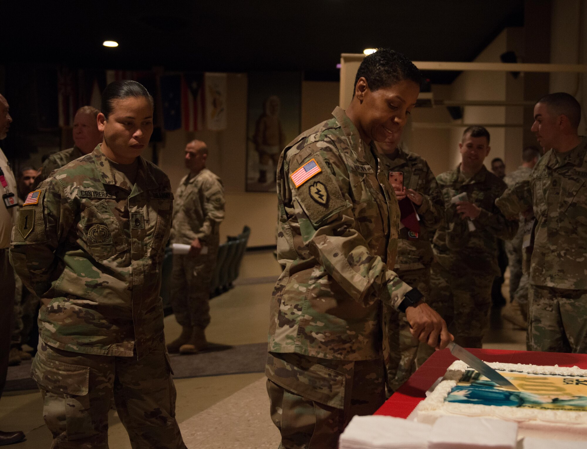 Command Sgt. Maj. Pamela Brown, 17th Combat Support and Sustainment Battalion senior enlisted advisor, cuts the cake Joint Base Elmendorf-Richardson's Women's Equality Day observance at the Frontier Theater Aug. 24. The observance celebrated 96 years since the passing of the 19th Amendment, which allowed women the right to vote. (U.S. Air Force photo by Senior Airman Kyle Johnson)