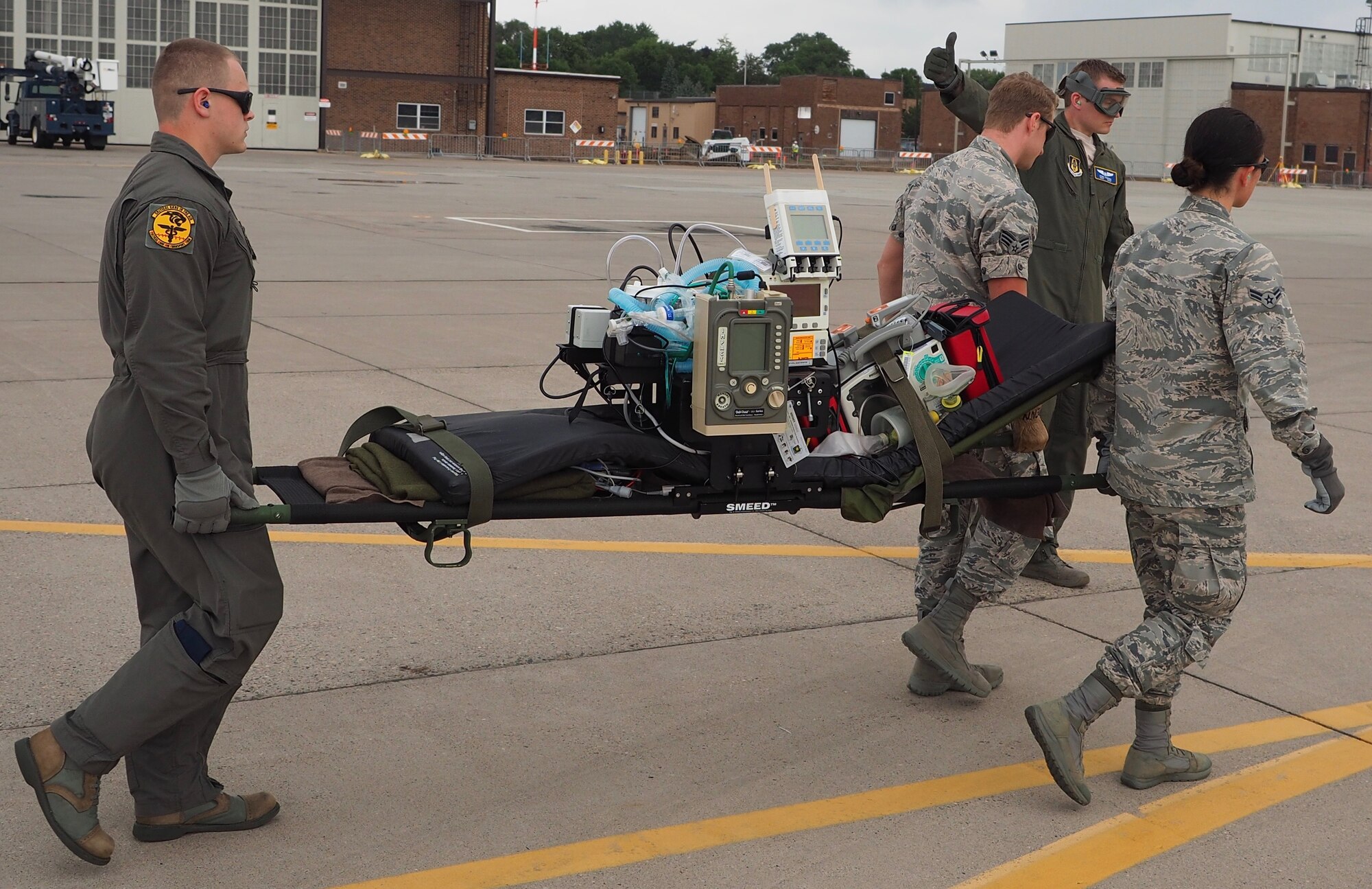 Air Force Reservists load 'patients' on to a C-130 with engines running at Minneapolis-St. Paul Air Reserve Station, Minn.  as part of exercise Patriot Warrior.  The multiservice exercise was designed to test the ability of medical personnel to treat patients in the field and transfer them to larger better equipped facilities during simulated wartime conditions.   
