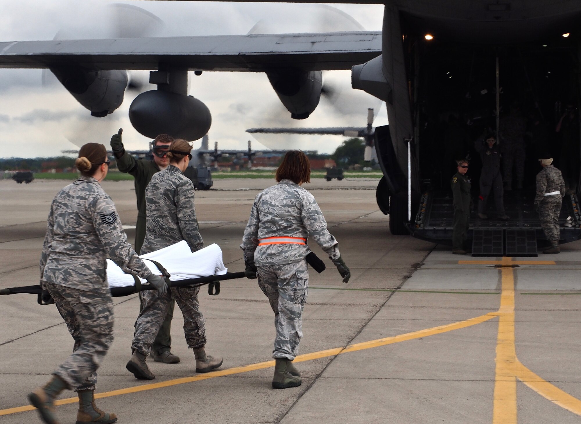 Air Force Reservists load 'patients' on to a C-130 with engines running at Minneapolis-St. Paul Air Reserve Station, Minn.  as part of exercise Patriot Warrior.  The multiservice exercise was designed to test the ability of medical personnel to treat patients in the field and transfer them to larger better equipped facilities during simulated wartime conditions.   