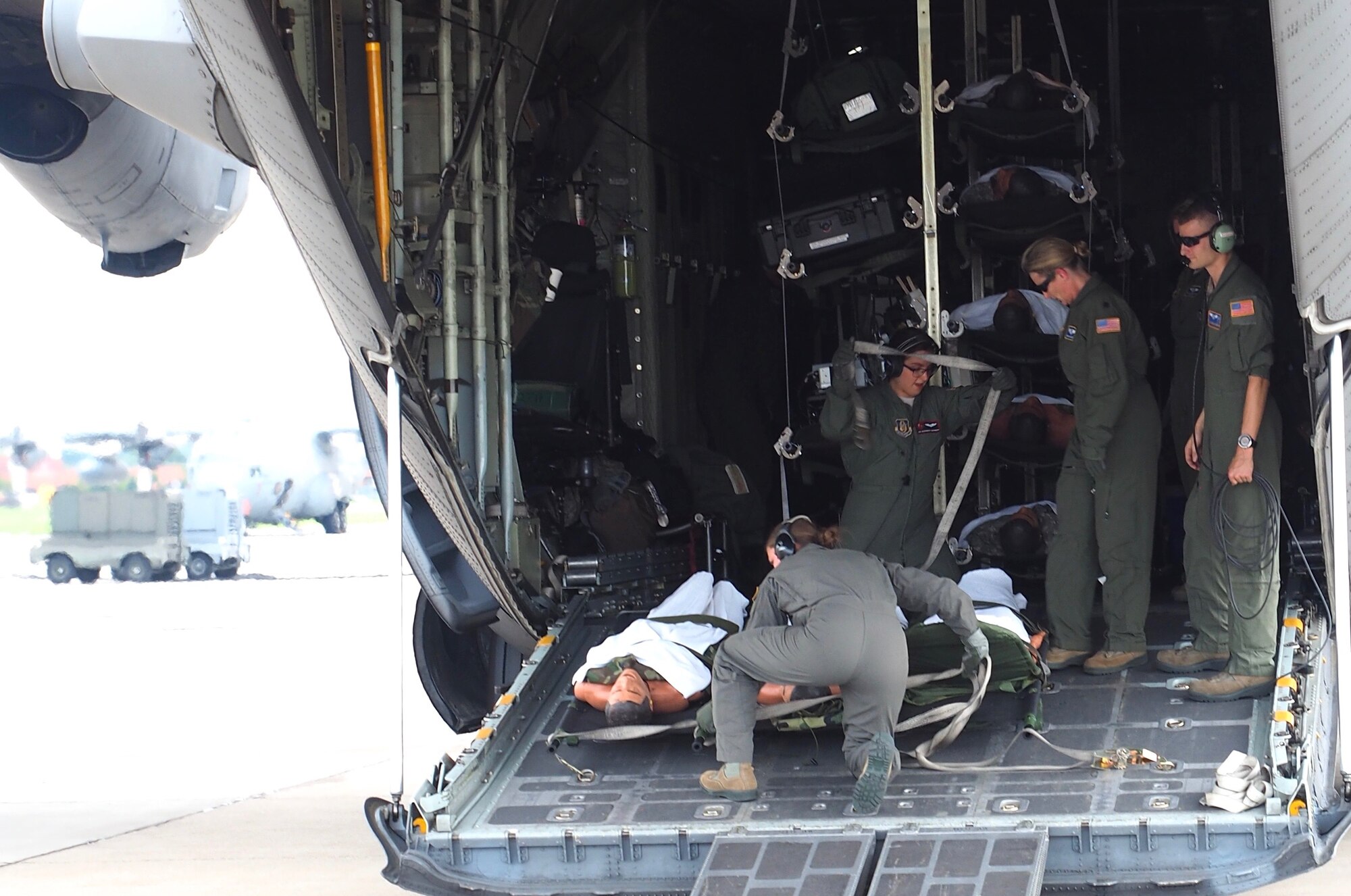 Air Force Reservists load 'patients' on to a C-130 with engines running at Minneapolis-St. Paul Air Reserve Station, Minn.  as part of exercise Patriot Warrior.  The multiservice exercise was designed to test the ability of medical personnel to treat patients in the field and transfer them to larger better equipped facilities during simulated wartime conditions.   