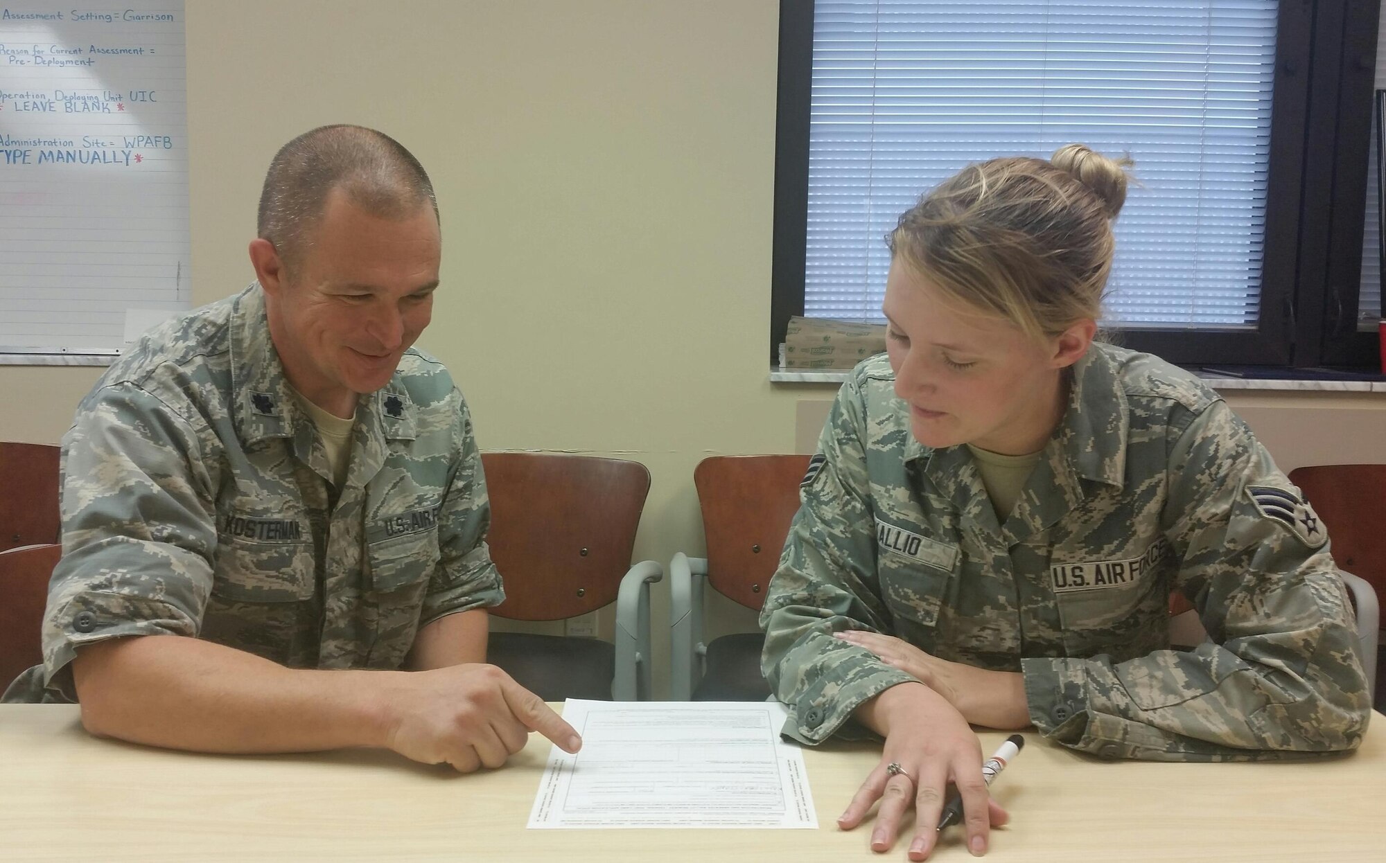 Lt. Col. Edward Kosterman, installation voting officer, reviews the Federal Voting Assistance Program paperwork and voting deadlines with Senior Airman Brittaney Kallio, 88th Air Base Wing, Judge Advocate. (U.S. Air Force photo/Laura McGowan)