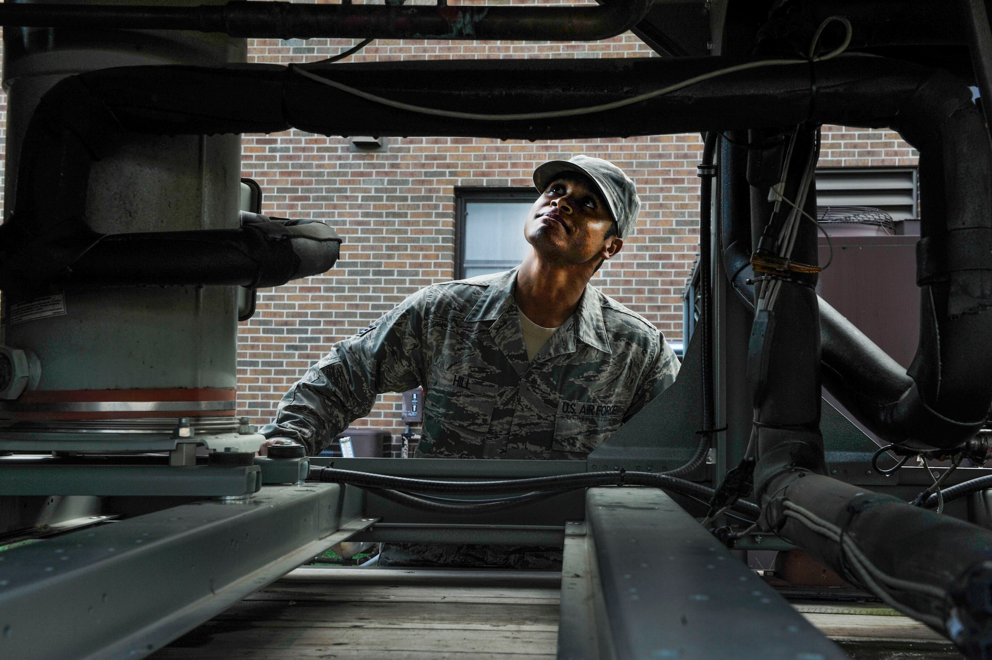 U.S. Air Force Senior Airman Pierre Hill, 19th Civil Engineer Squadron heating, ventilating and air conditioning journeyman, ensures the condenser coil of a portable chiller is clean and free of debris Aug. 9, 2016, at Little Rock Air Force Base, Ark.  Portable Chillers supply necessary cooling for buildings when the main air condintioning unit does not work properly. (U.S. Air Force photo by Senior Airman Stephanie Serrano) 