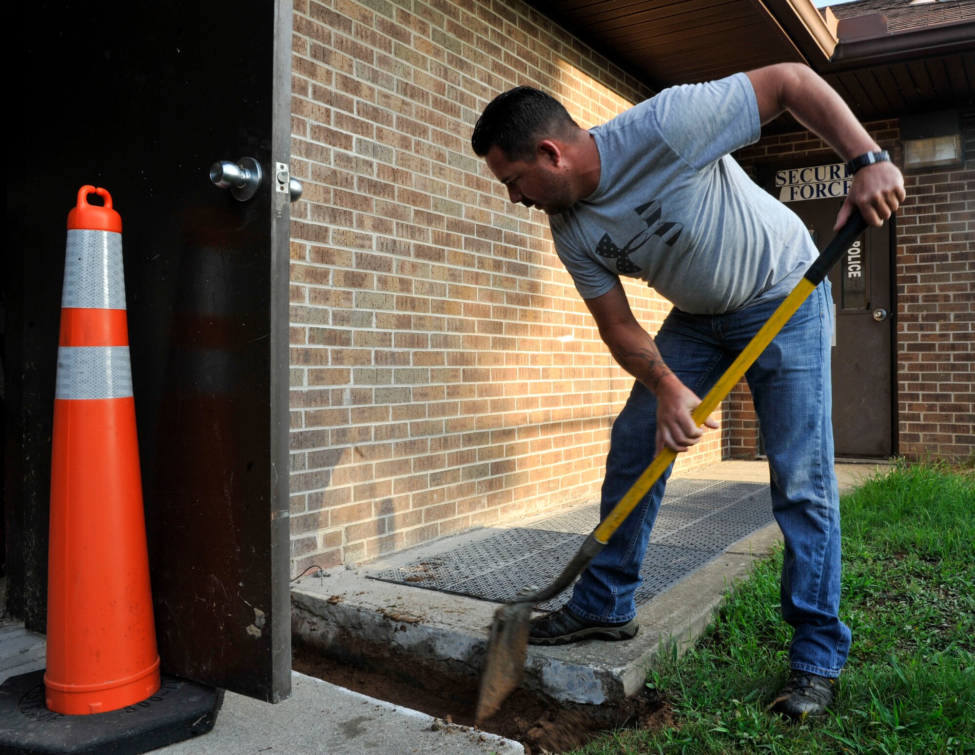 Norman Craig, 19th Civil Engineer Squadron contractor, creates space for a line system to an air conditioning unit Aug. 9, 2016, at Little Rock Air Force Base. The installed air conditioning unit will provide cool air to a military working dog kennel. (U.S. Air Force photo by Senior Airman Stephanie Serrano)