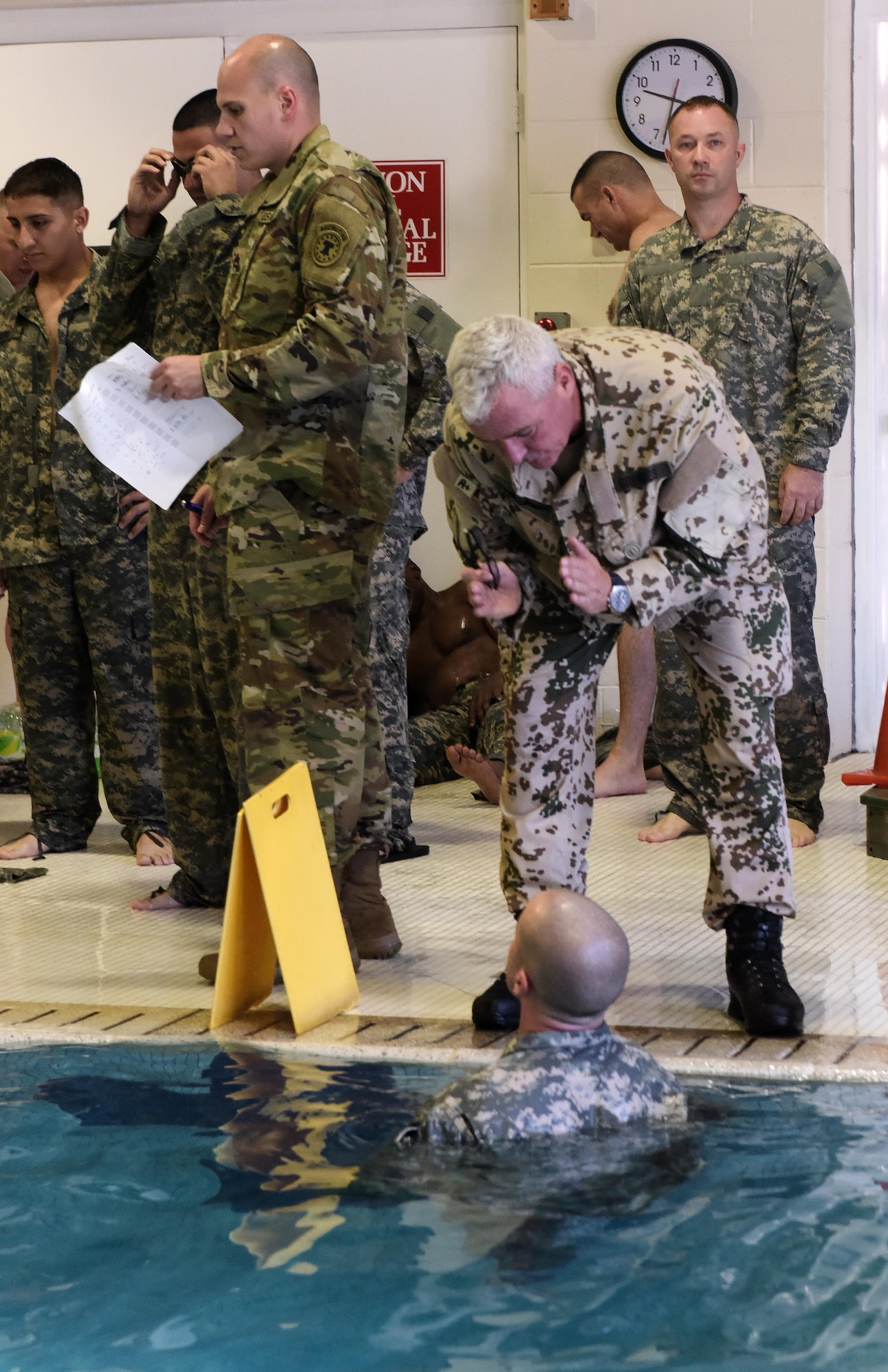 Command Sgt. Maj. Robert Grommes, German Armed Forces Command United States and Canada, gives direction to one of the GAFPB competitors during the swim portion of the event. (U.S. Air Force photo by Flores Pascual/released)
