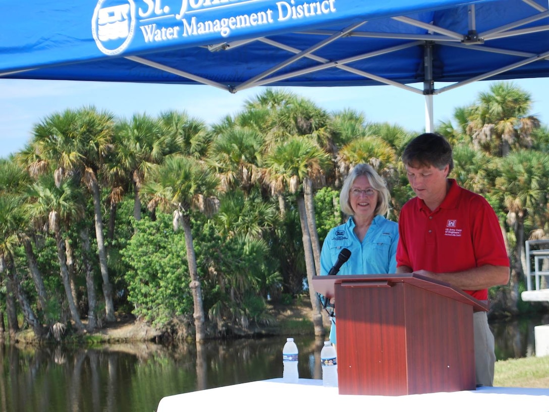 Tim Murphy and Dr. Ann Shortelle highlight successes of the St. Johns River Upper Basin Project during a ceremony Aug. 23 at the Fellsmere Grade Recreation Area where a large group gathered to celebrate the project’s completion. Murphy, Jacksonville District deputy for Programs and Project Management, and Shortelle, executive director of the St. Johns River Water Management District, and other key speakers consistently mentioned the partnership and perseverance over four decades that built nature back into the basin system to provide flood protection, marsh restoration, isolate agricultural runoff and freshwater releases into the Indian River Lagoon, and restore wildlife habitat over 166,000 acres in Brevard and Indian River counties. In July 2016 the upper basin project was recognized as the “Project of the Century” by the Florida Society of Engineers, competing against such inventive projects as air conditioning and the Hubble Space Telescope. According to the engineering committee, the projects illustrated “long‐term engineering solutions providing for the betterment of the citizens of the state, their health, public safety, and welfare. These projects provide witness of engineering excellence in their local community." 
Link to Florida Society of Engineers’ Journal that highlights projects of the century:   http://www.fleng.org/images/files/files/2016%20July%20Journal%20web.pdf
