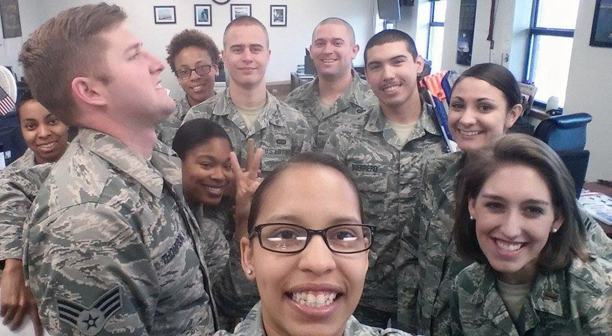 U.S. Air Force Senior Airman Shannon Hall, center, takes a photo with her co-workers to celebrate her original Air Force anniversary March 3, 2015, at Dyess Air Force Base, Texas. Hall joined the Air Force March 3, 2009 and was medically retired in 2011. When she found out she was misdiagnosed and fought to get back in, she re-enlisted January 28, 2013. (Courtesy photo)