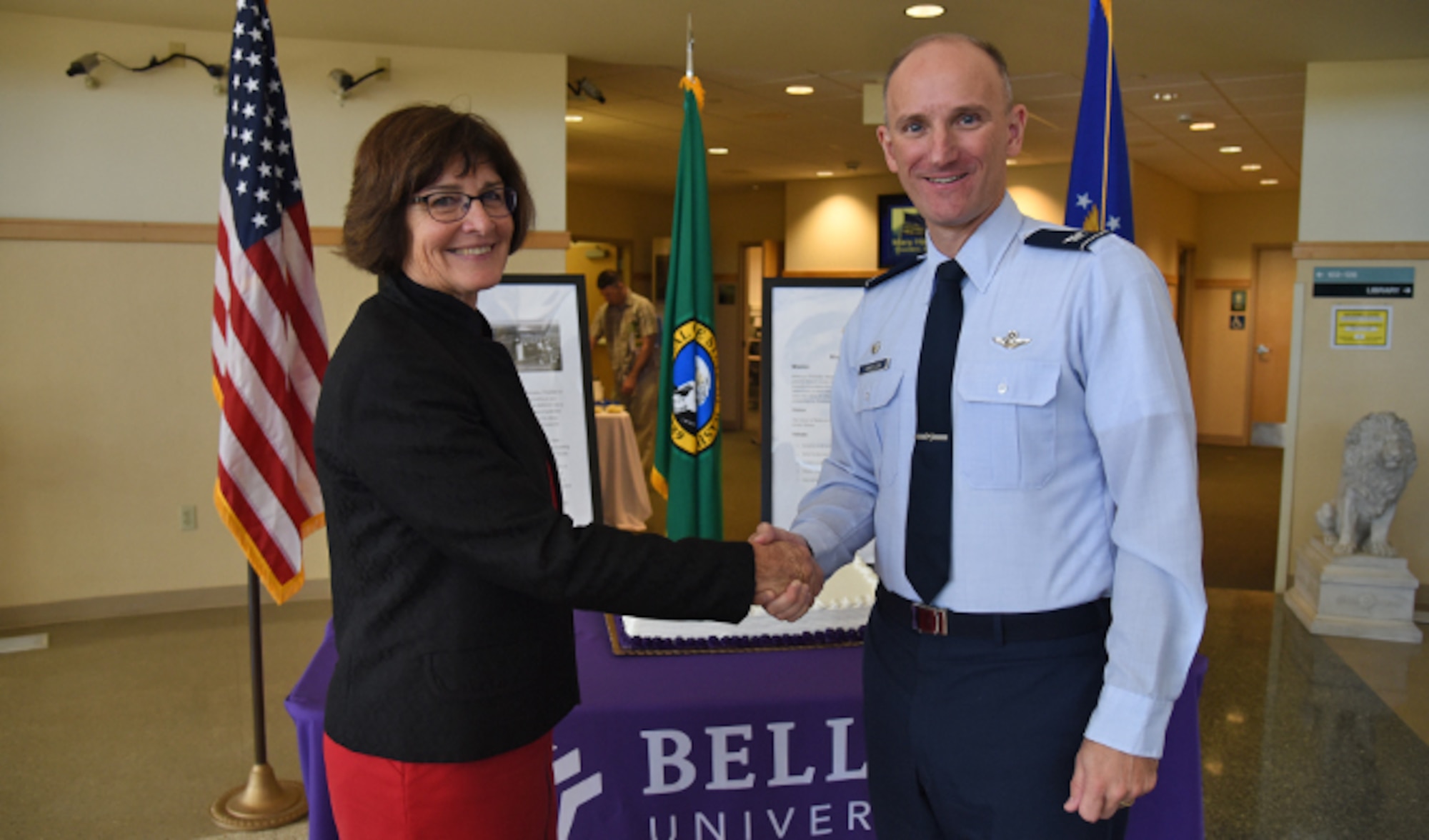 Col. Ryan Samuelson, 92nd Air Refueling Wing commander, and Dr. Mary Hawkins, Bellevue University president, celebrate the opening of Bellevue University at the Fairchild Education Center during the ribbon-cutting ceremony Aug. 25, 2016, at Fairchild Air Force Base. Bellevue University will offer three of its most popular graduate programs at Fairchild: Master of Science in Human Resource Management, Master of Business Administration and Master of Science in Cybersecurity. (U.S. Air Force photo/Airman 1st Class Mackenzie Richardson)