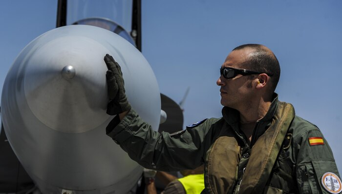 A Spanish air force pilot performs preflight checks of an EF-18M on the runway at Nellis Air Force Base, Nev., before participating in Red Flag 16-4, Aug. 17, 2016. Red Flag is one of a series of advanced training programs administered by the U.S. Air Force Warfare Center. (U.S. Air Force photo by Airman 1st Class Kevin Tanenbaum/Released)