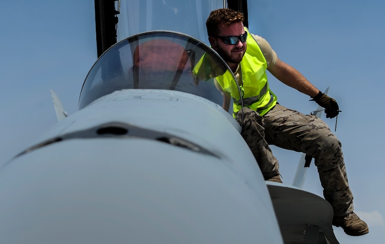 A Spanish air force maintainer prepares the cockpit of an EF-18M during Red Flag 16-4 at Nellis Air Force Base, Nev., Aug. 17, 2016. Just northwest of Nellis AFB lies the 2.9 million-square-acre Nevada test and Training Range which provides a realistic arena for operational testing and training aircrews to improve combat readiness. (U.S. Air Force photo by Airman 1st Class Kevin Tanenbaum/Released)