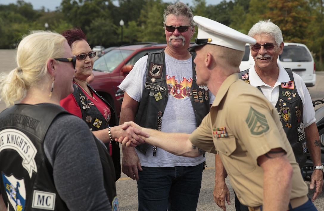 Staff Sgt. Thomas F. Stewart, Vietnam War commemoration liaison staff noncommissioned officer with the Office of U.S. Marine Corps Communication, greets members of various military and first-responder veteran motorcycle clubs at the Goldring/Woldenberg Great Lawn in City Park, New Orleans, Aug. 24, 2016.  The motorcycle clubs escorted an 80-percent replica of the Vietnam Memorial in Washington to the park. The Marine Corps brought the wall to New Orleans as part of a commemorative plan to honor and remember the 50th anniversary of the Vietnam War. The wall arrived in conjunction with Marine Forces Reserve’s Centennial celebration, which began with events in New Orleans this week. (U.S. Marine Corps photo by Sgt. Ian Leones/Released)