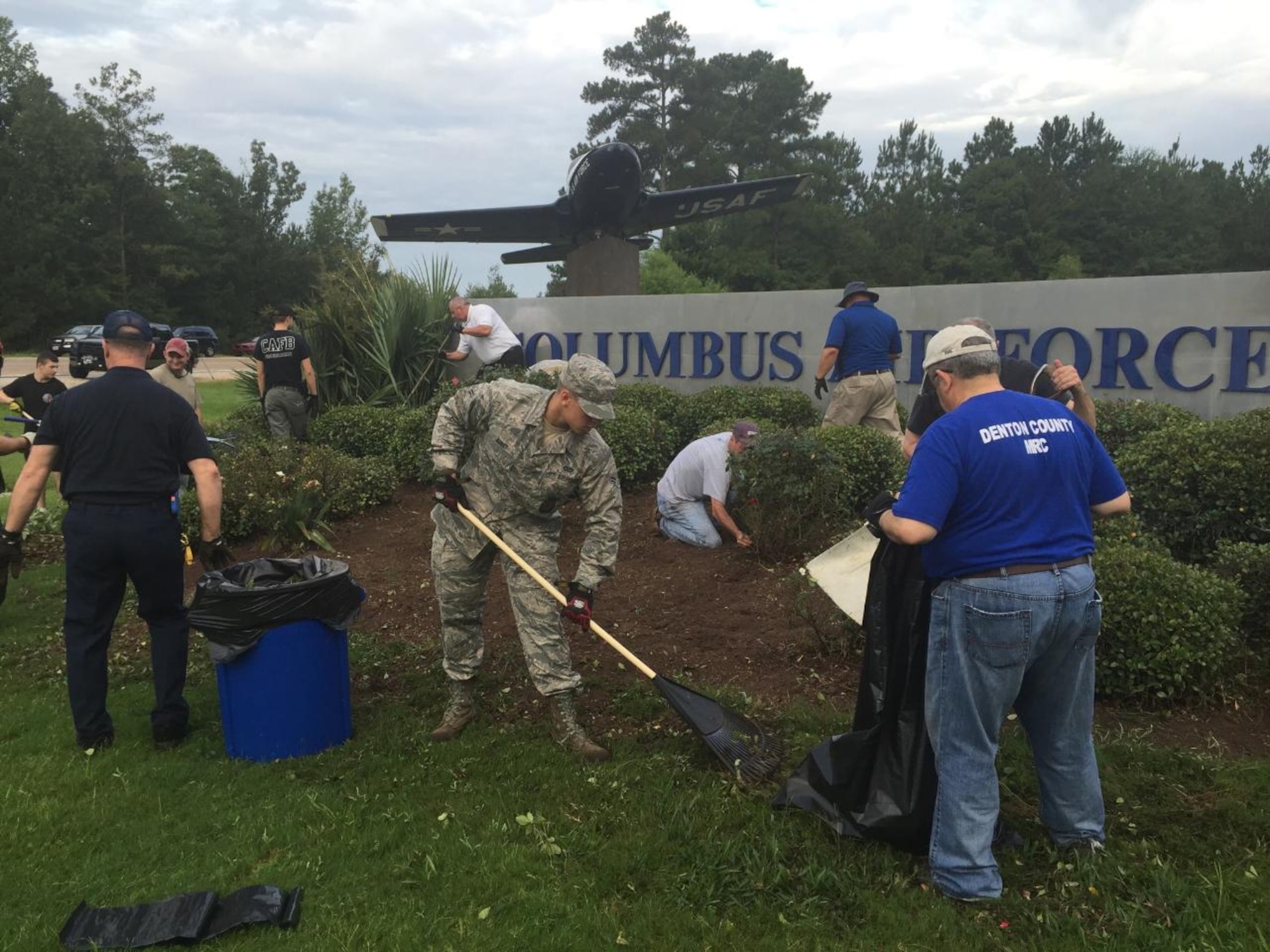 More than 20 Columbus community members and base personnel work together to clean up the landscape around the T-37 static Display on Highway 45 Aug. 20 in front of Columbus Air Force Base, Mississippi. (Courtesy Photo)
