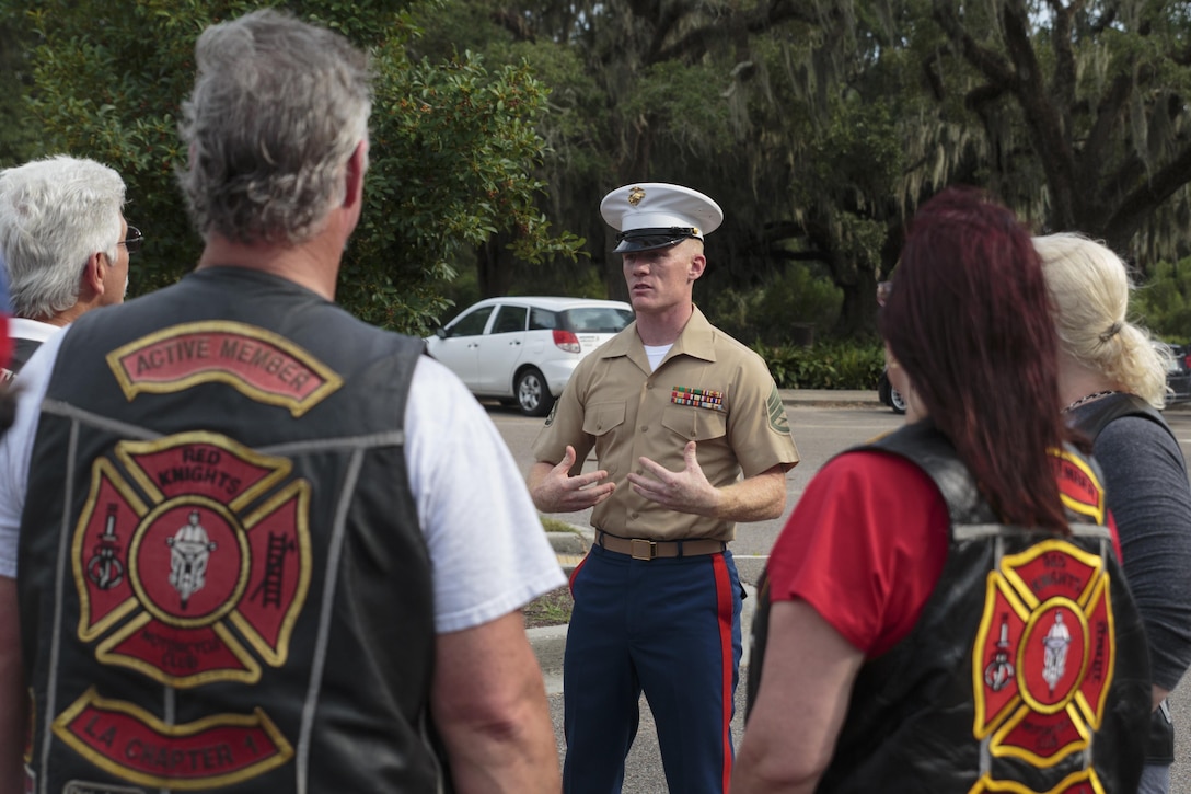 Staff Sgt. Thomas F. Stewart, Vietnam War commemoration liaison staff noncommissioned officer with the Office of U.S. Marine Corps Communication, greets members of various military and first-responder veteran motorcycle clubs at the Goldring/Woldenberg Great Lawn in City Park, New Orleans, Aug. 24, 2016.  The motorcycle clubs escorted an 80-percent replica of the Vietnam Memorial in Washington to the park. The Marine Corps brought the wall to New Orleans as part of a commemorative plan to honor and remember the 50th anniversary of the Vietnam War. The wall arrived in conjunction with Marine Forces Reserve’s Centennial celebration, which began with events in New Orleans this week. (U.S. Marine Corps photo by Sgt. Ian Leones/Released)
