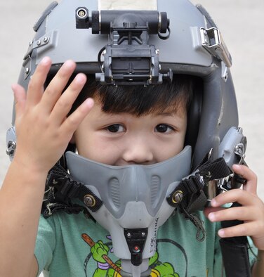 Sizing up a future as a C-130 Hercules flyer, Liam Mounty tries on one of the 302nd Operations Support Squadron's training tactical helmets during the annual Herc Adventure Tour at Peterson Air Force Base, Colo., Aug. 6, 2016. The Herc Adventure Tour provides Air Force Reservists and their families the opportunity to tour the 302nd Airlift Wing's assigned aircraft as well as experience the equipment operated by several other organizations within the wing. Liam's father is Staff Sgt. Wanytha Mounty, a squadron aviation resource management specialist assigned to the 731st Airlift Squadron. (U.S. Air Force photo/2nd Lt. Stephen J. Collier)