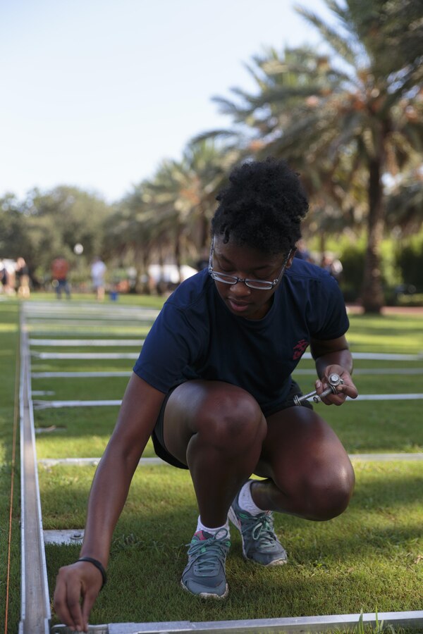 Diamond A. Harriel, a poolee with Marine Corps Recruiting Substation New Orleans, helps assemble an 80-percent scale replica of the Vietnam Memorial Wall at the Goldring/Woldenberg Great Lawn in City Park, New Orleans, Aug. 25, 2016. The Marine Corps brought the wall to New Orleans as part of a commemorative plan to honor and remember the 50th anniversary of the Vietnam War. The wall arrived in conjunction with Marine Forces Reserve’s Centennial celebration, which began with events in New Orleans this week. (U.S. Marine Corps photo by Sgt. Ian Leones/Released)